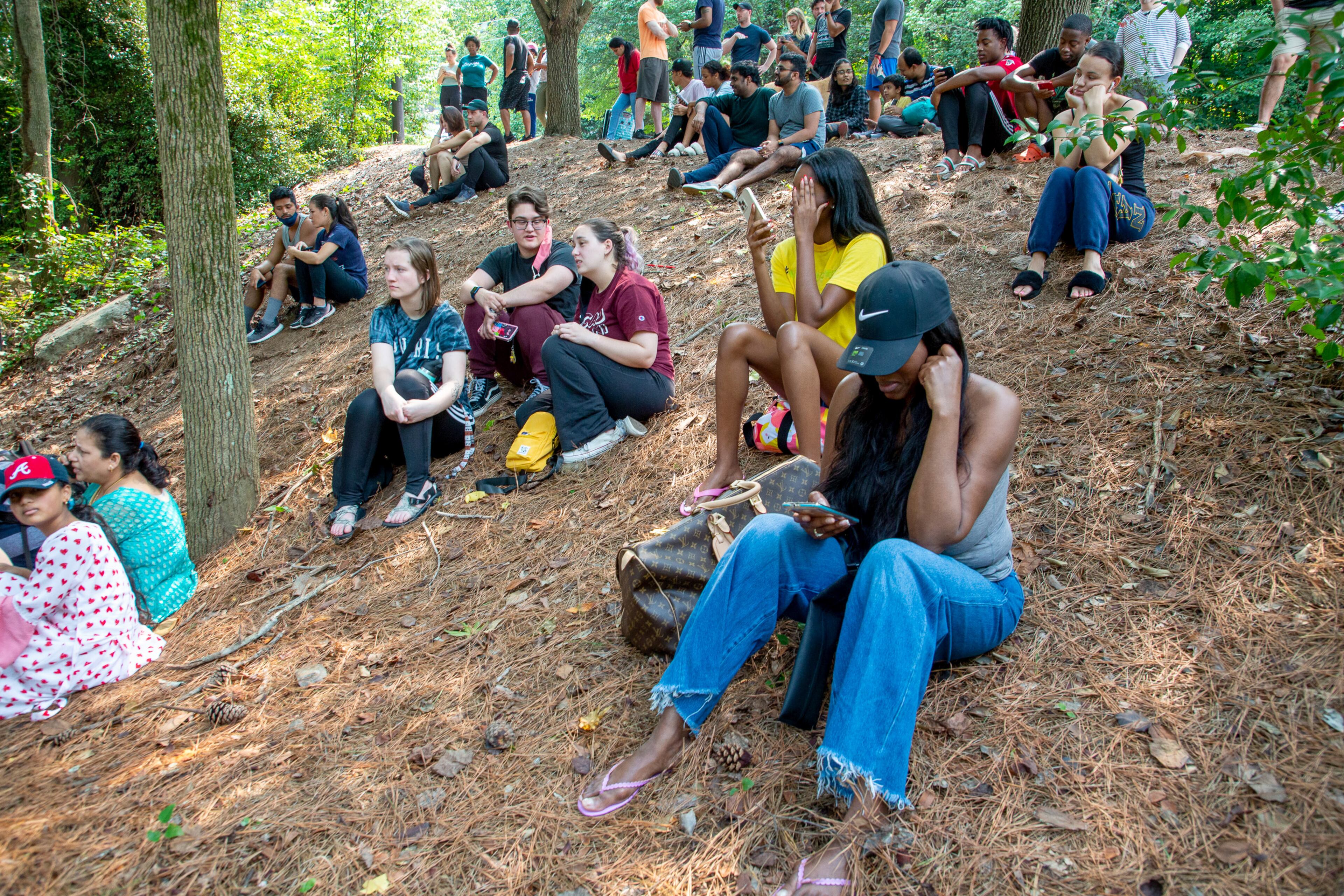 Residents of the Arrive Perimeter apartment complex in Dunwoody sit on the roadside after an explosion damaged their building Sunday, September 12, 2021. STEVE SCHAEFER FOR THE ATLANTA JOURNAL-CONSTITUTION