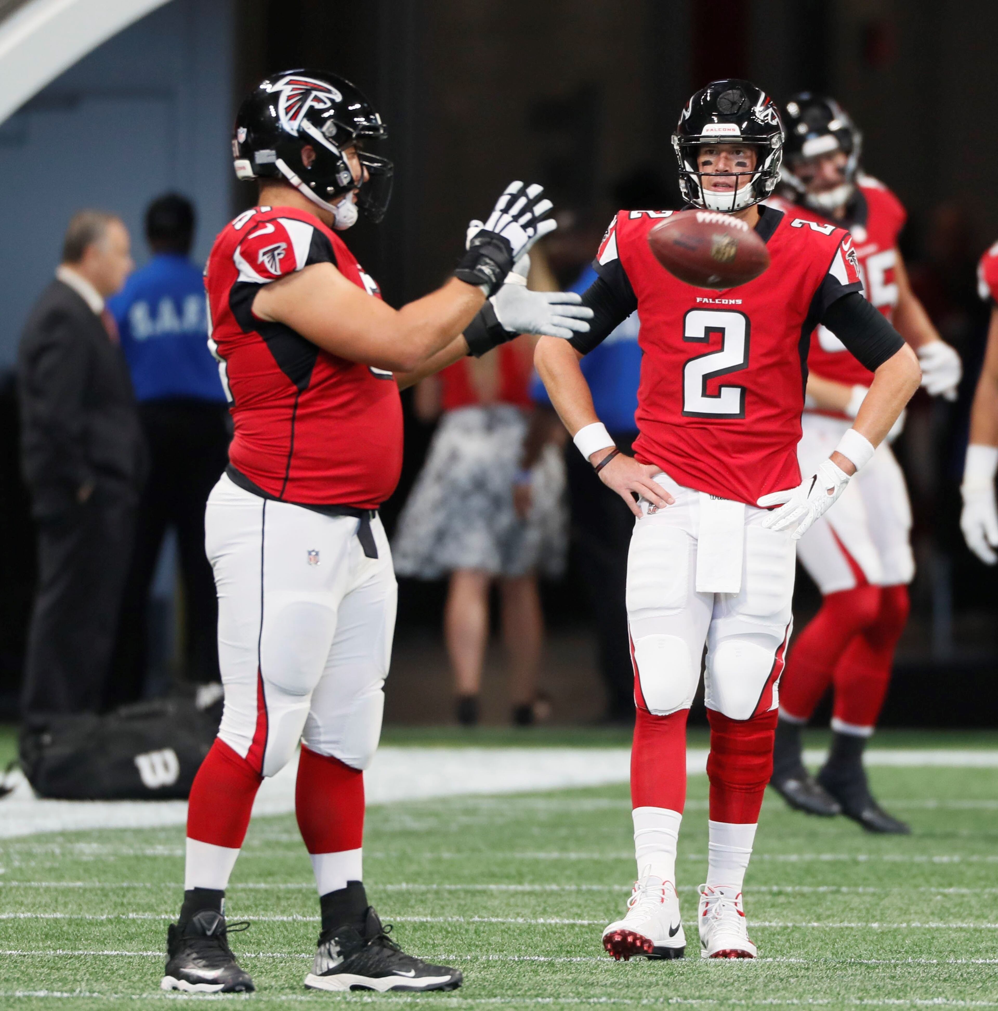 9/23/18 - Atlanta - Atlanta Falcons quarterback Matt Ryan (2) and Atlanta Falcons center Alex Mack (51) take the field for pregame warmups. The Atlanta Falcons played the New Orleans Saints in an NFL football game Sunday, Sept 23, 2018, at Mercedes-Benz Stadium in Atlanta, GA. BOB ANDRES /BANDRES@AJC.COM