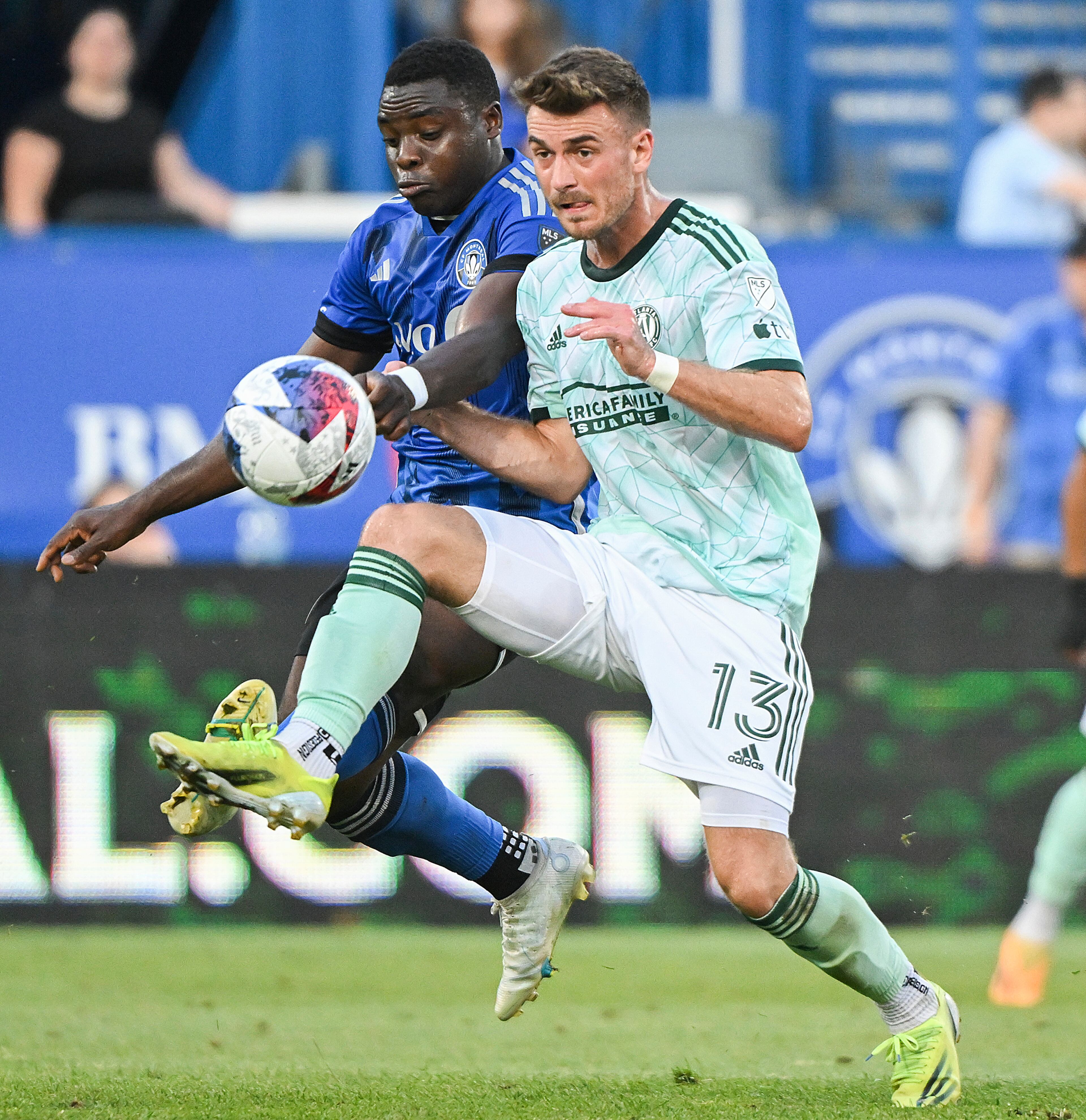 CF Montreal's Sunusi Ibrahim, left, defends against Atlanta United's Amar Sejdic (13) during the first half of an MLS soccer match Saturday, July 8, 2023, in Vancouver, British Columbia. (Graham Hughes/The Canadian Press via AP)