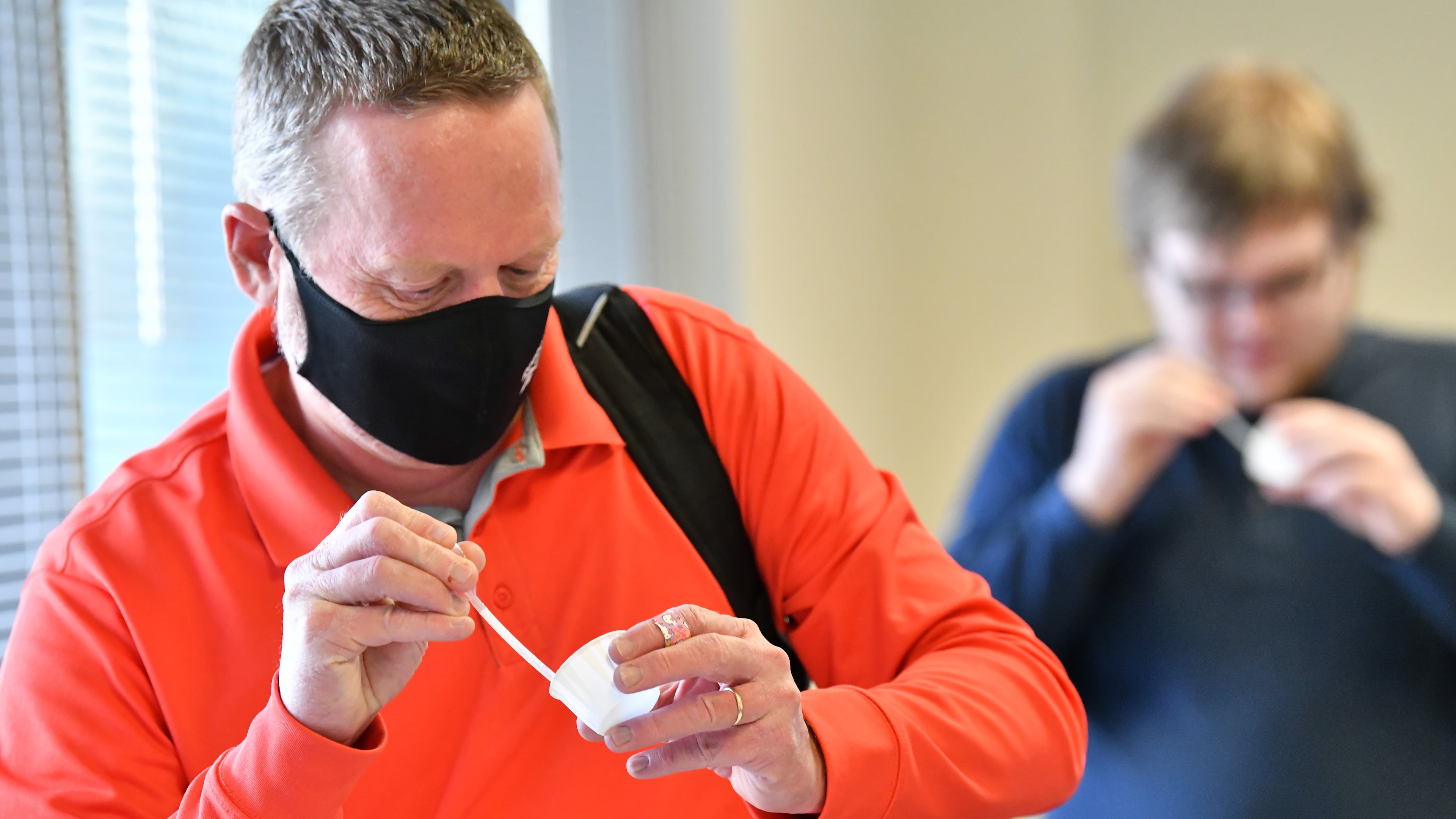 January 4, 2022 Atlanta - Donald Smith (foreground) and his son Jacob Smith, both Georgia Tech employees collect their saliva samples for PCR COVID test at Georgia Tech’s Economic Development Building on Tuesday, January 4, 2022. (Hyosub Shin / Hyosub.Shin@ajc.com)