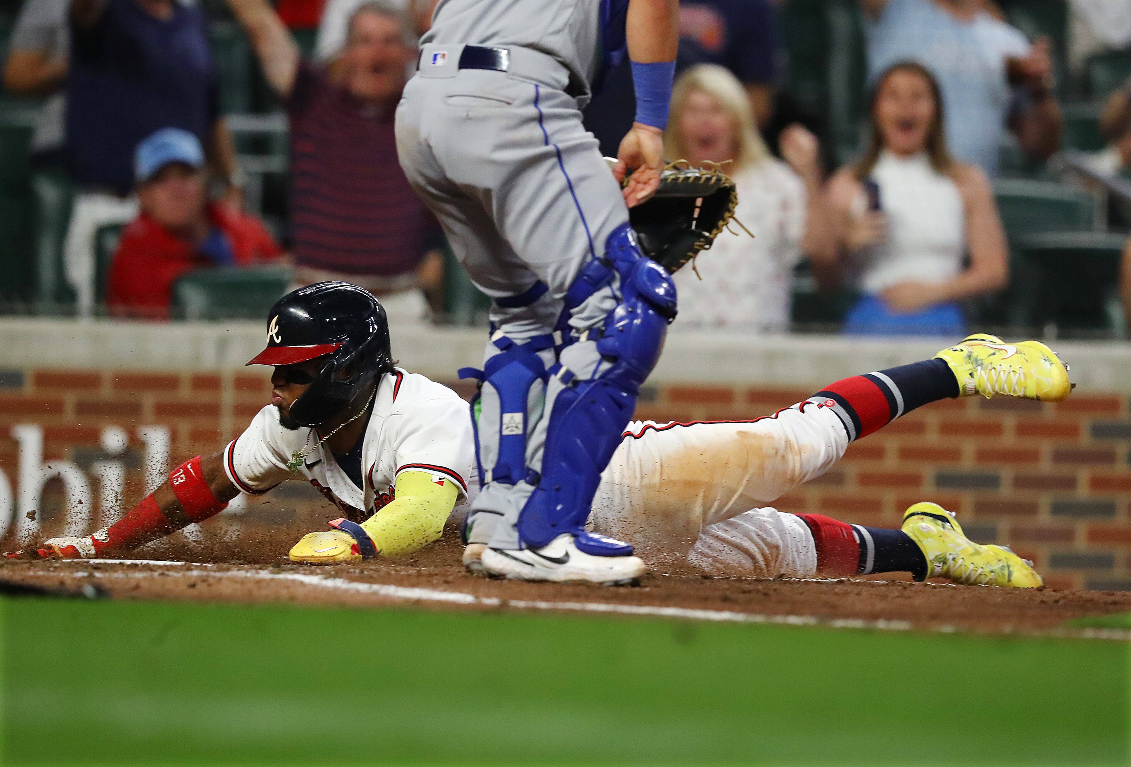 Braves outfielder Ronald Acuna slides home to score all the way from first base on a RBI-single by Dansby Swanson for a 4-0 lead over the New York Mets during the seventh inning in a MLB baseball game on Tuesday, August 16, 2022, in Atlanta. Acuna scored after drawing his fourth base on balls in the game. “Curtis Compton / Curtis Compton@ajc.com