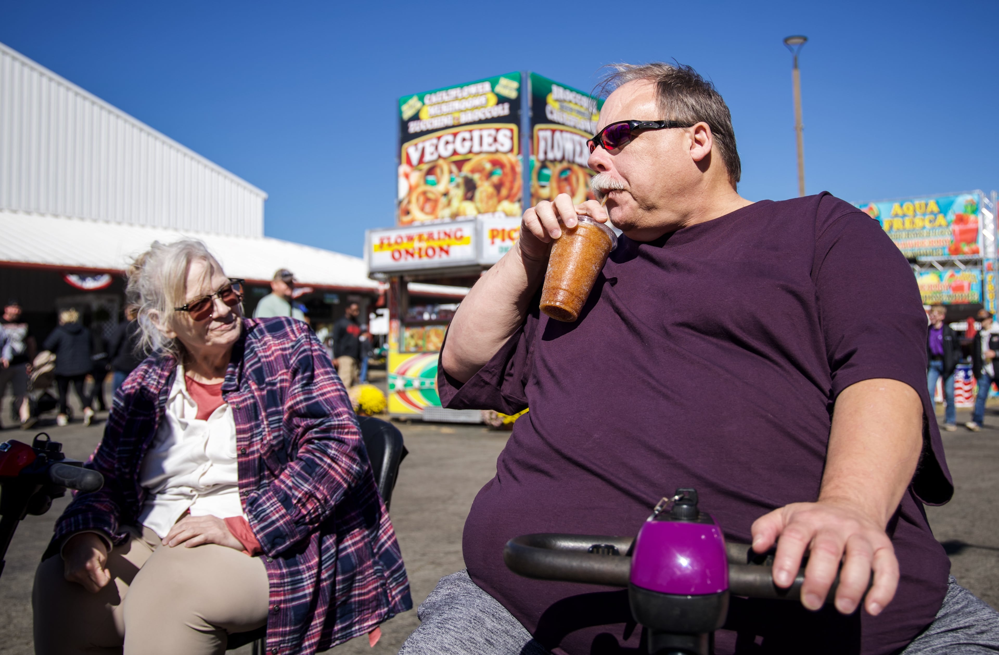 Steven Schreck and his wife Dottie Schreck, from Cartersville, Georgia, try a sweet tea slushy at the Georgia National Fair in Perry, Georgia, on Oct. 17, 2026. The Schrecks spent the day at the fair with their son David. (Emily Laycock/UGA Photojournalism Workshop)