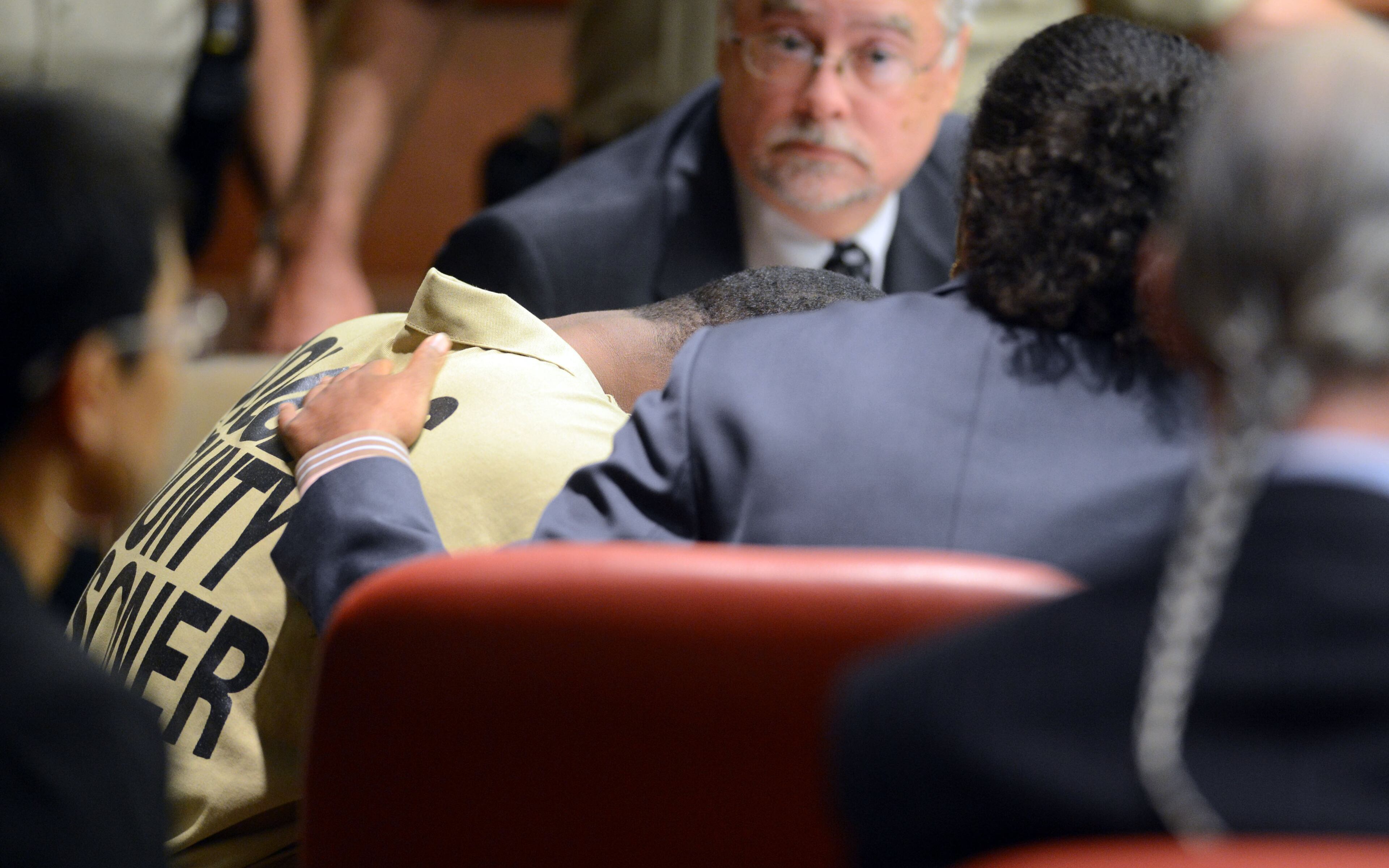 Tracen Franklin is consoled by Jerilyn Bell (right) of the Georgia Capital Defenders Office following his statement to the court.