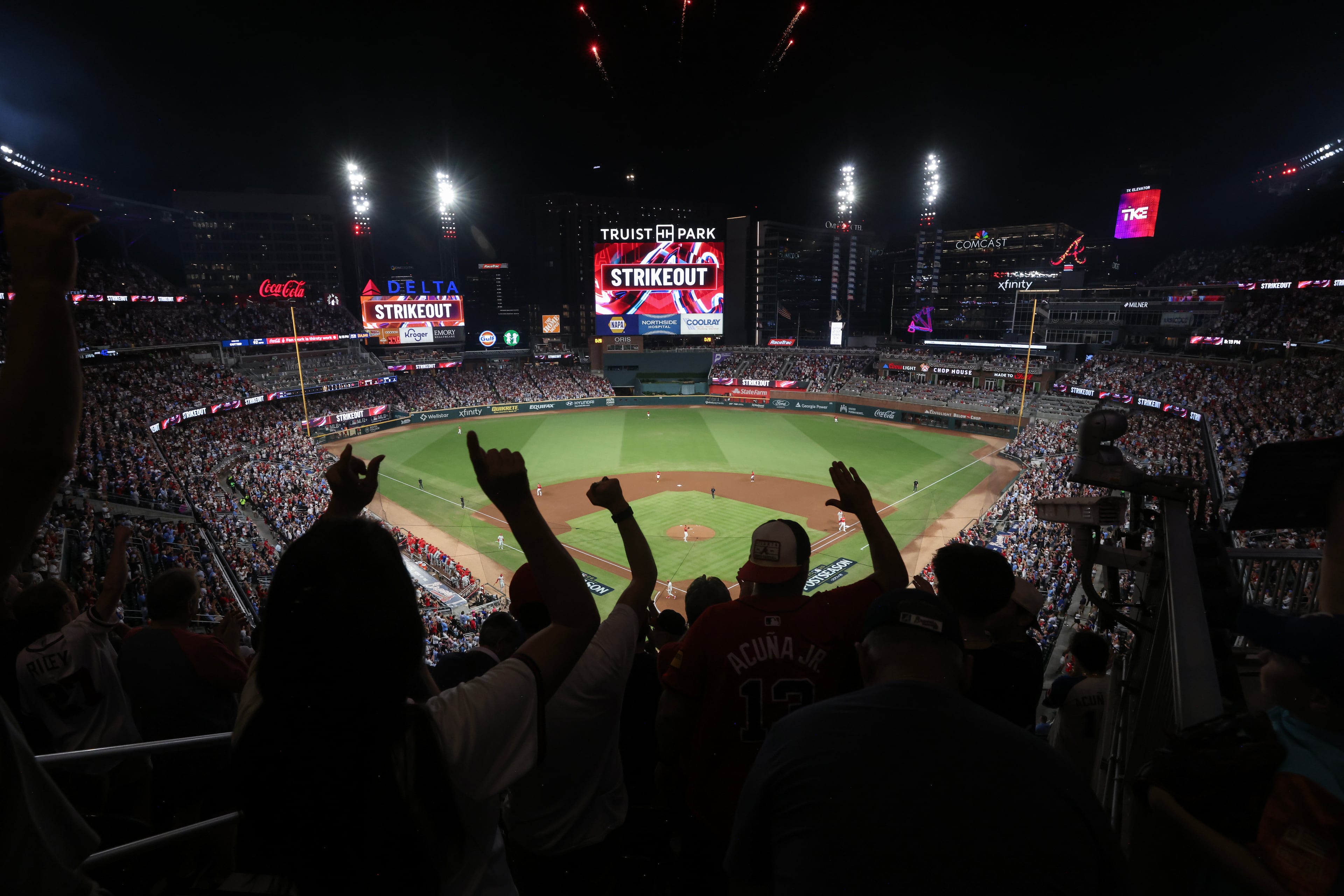 Atlanta Braves fans react after Atlanta Braves starting pitcher Ray Kerr struck out Philadelphia Phillies' Bryce Harper during the first inning of Game 3 of a MLB National League Wild Card playoff series between the Atlanta Braves and the Philadelphia Phillies, Thursday, Oct. 1, 2026, in Atlanta. (Jason Getz/AJC)