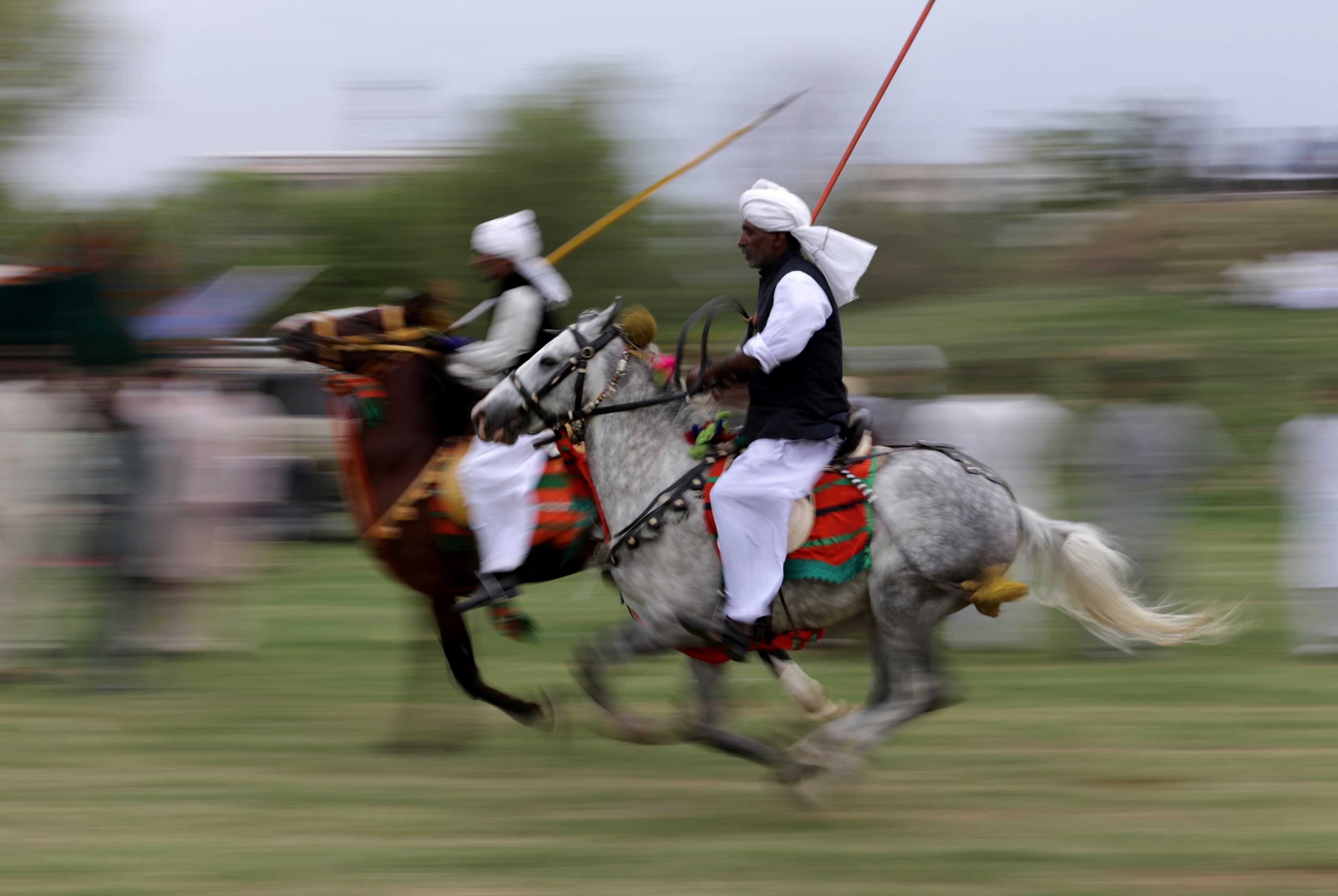 Pakistani riders proceed to their targets during competition organized by the Pakistan Tent Pegging Association in Islamabad, Pakistan, Friday, April 21, 2017. In tent pegging, a horseman gallops and uses a sword or a lance to pierce, pick up, and carry away a wooden peg. (AP Photo/B.K. Bangash)