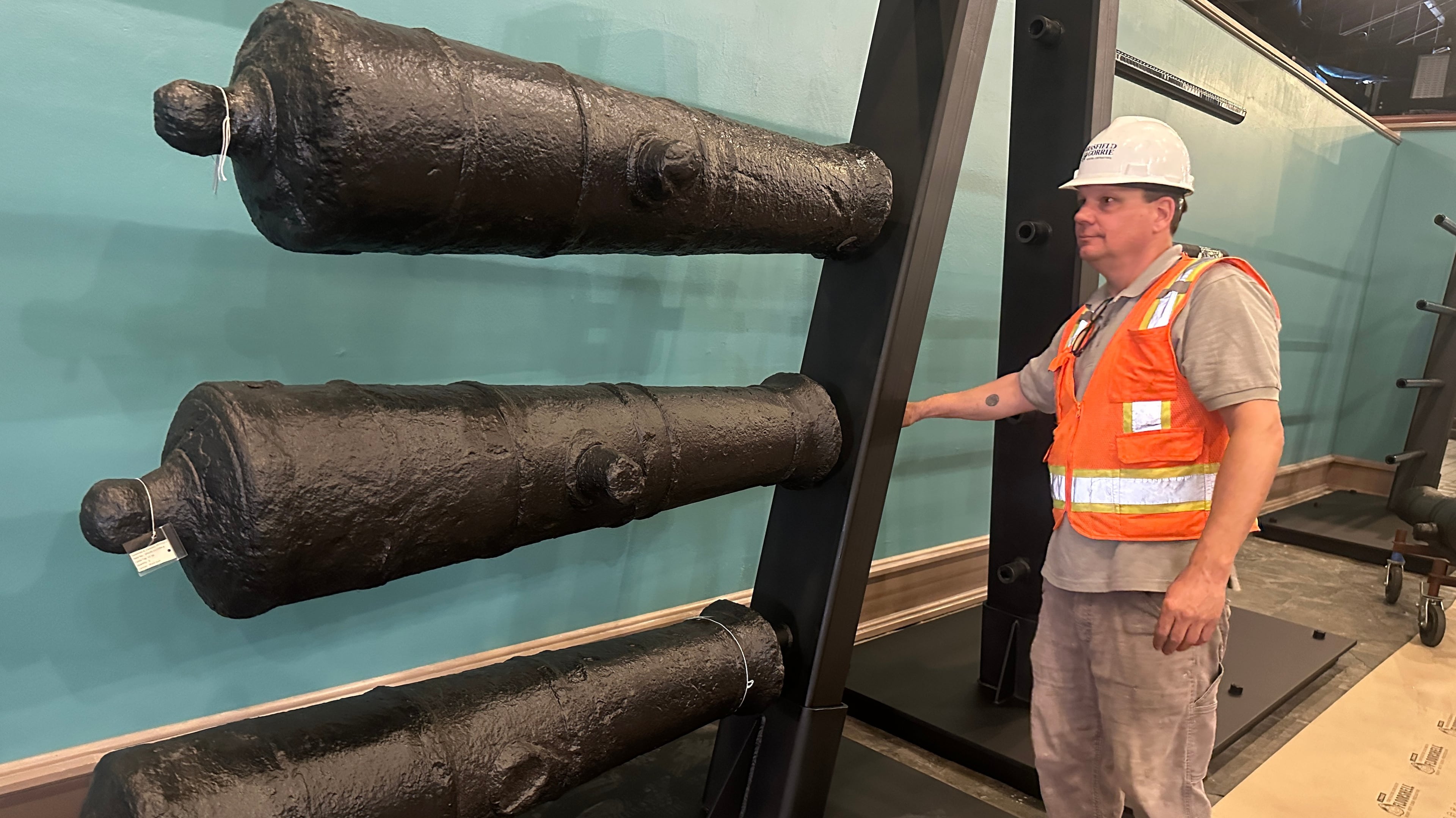 Terry Koeller inspects cannons, which sunk to the bottom of the Savannah River during the American Revolution, on a rack at the Savannah History Museum in Savannah, Ga., on Wednesday, June 3, 2026. (AP Photo/Russ Bynum)