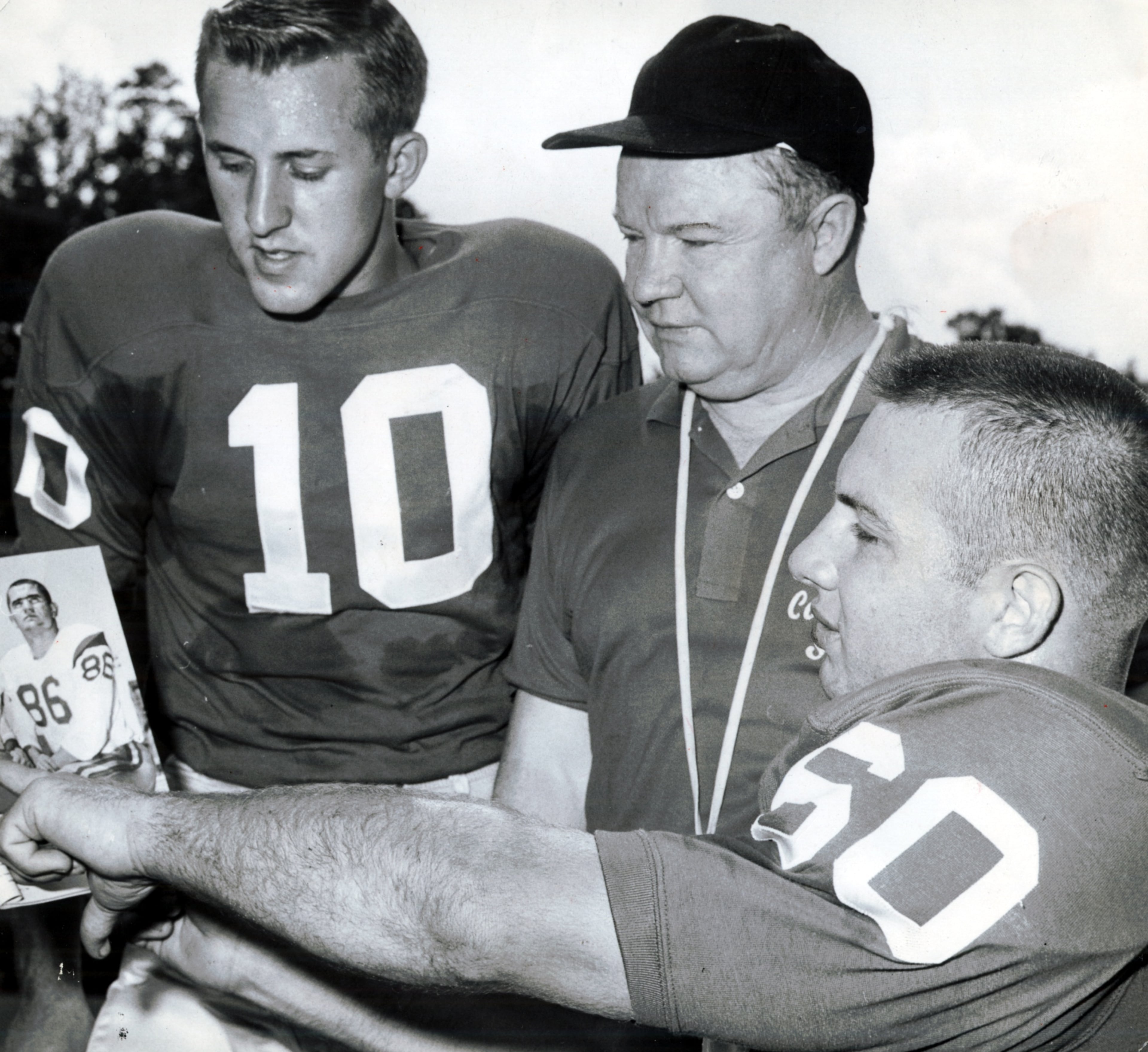 QB Fran Tarkenton (left) and lineman Pat Dye (right) discuss an opponent with coach Wally Butts in 1959. (Bill Young/AJC staff)