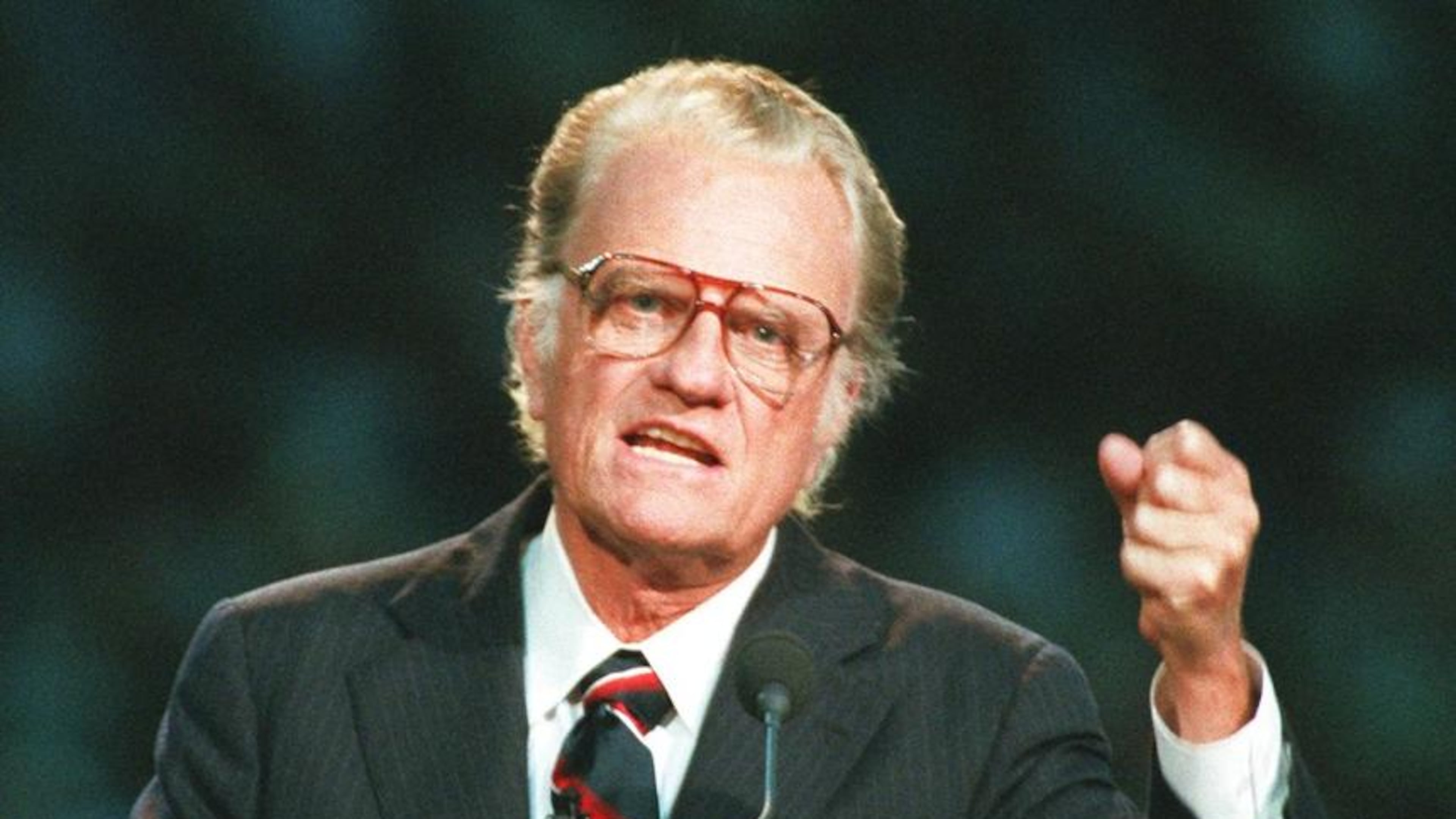 In this Oct 26, 1994 file photo, Evangelist Billy Graham begins his sermon in Atlanta's Georgia Dome. Graham, who transformed American religious life through his preaching and activism, becoming a counselor to presidents and the most widely heard Christian evangelist in history, has died. Spokesman Mark DeMoss says Graham, who long suffered from cancer, pneumonia and other ailments, died at his home in North Carolina on Wednesday, Feb. 21, 2018. He was 99. AP Photo/John Bazemore, File