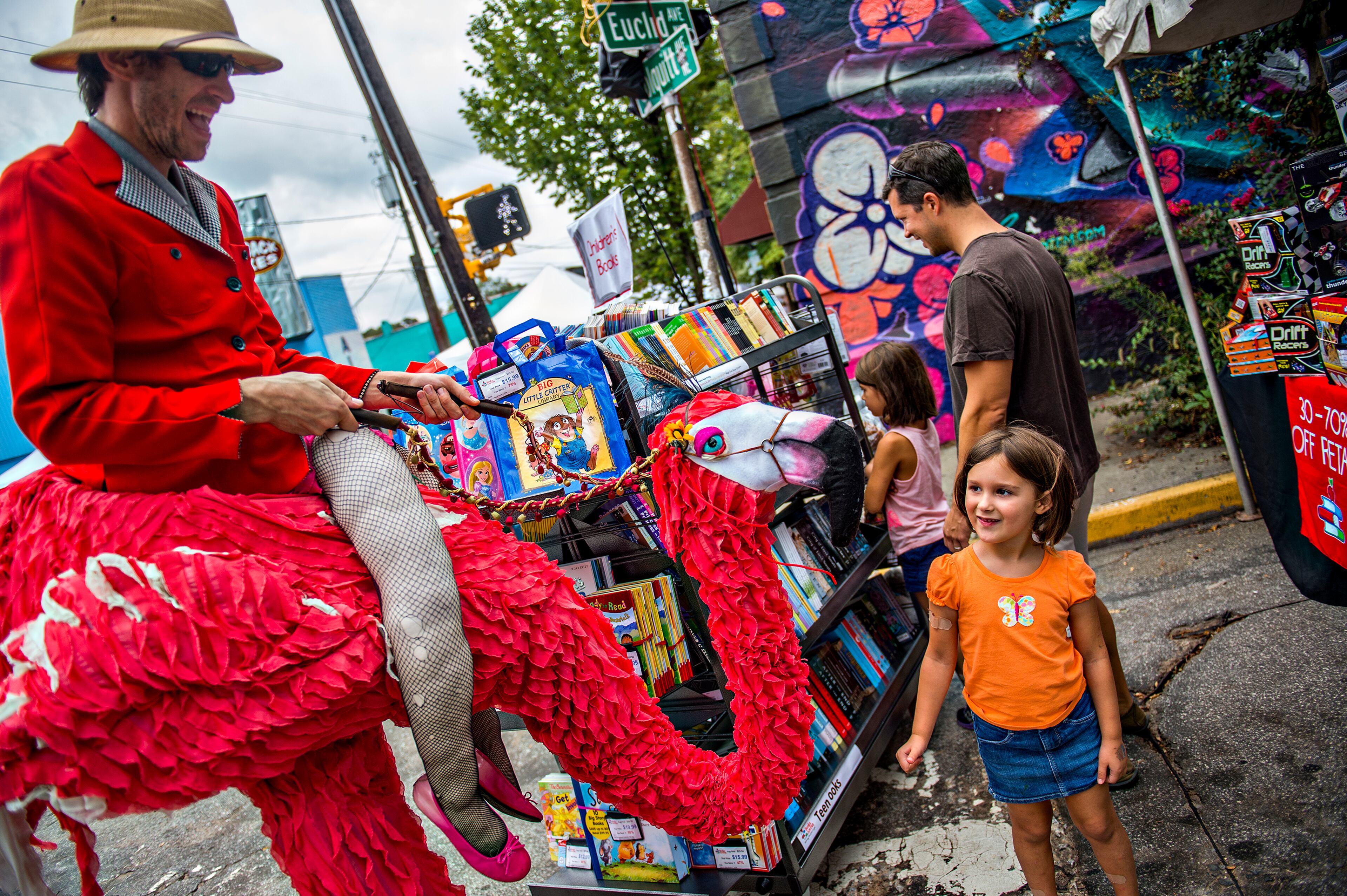 September 12, 2015 Atlanta - Tony Schott (left) rides up to Maya Rosenkoetter on his flamingo during the 5 Arts Fest in the Little Five Points neighborhood of Atlanta on Saturday, September 12, 2015. In its second year, the 5 Arts Fest brings together the community to participate in literary, visual, recording and performing arts as well as arts and crafts projects. JONATHAN PHILLIPS / SPECIAL