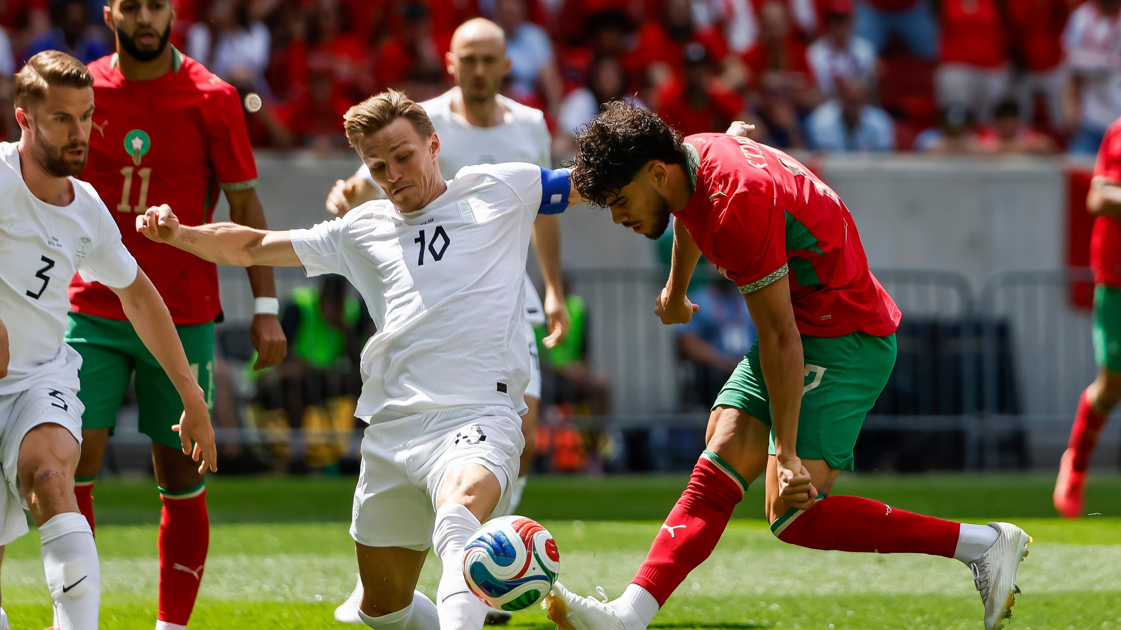 Norway midfielder Martin Odegaard (10) fights for the ball against Morocco forward Abde Ezzalzouli during an international friendly soccer match, Sunday, June 7, 2026, in Harrison, N.J. (AP Photo/Eduardo Munoz Alvarez)
