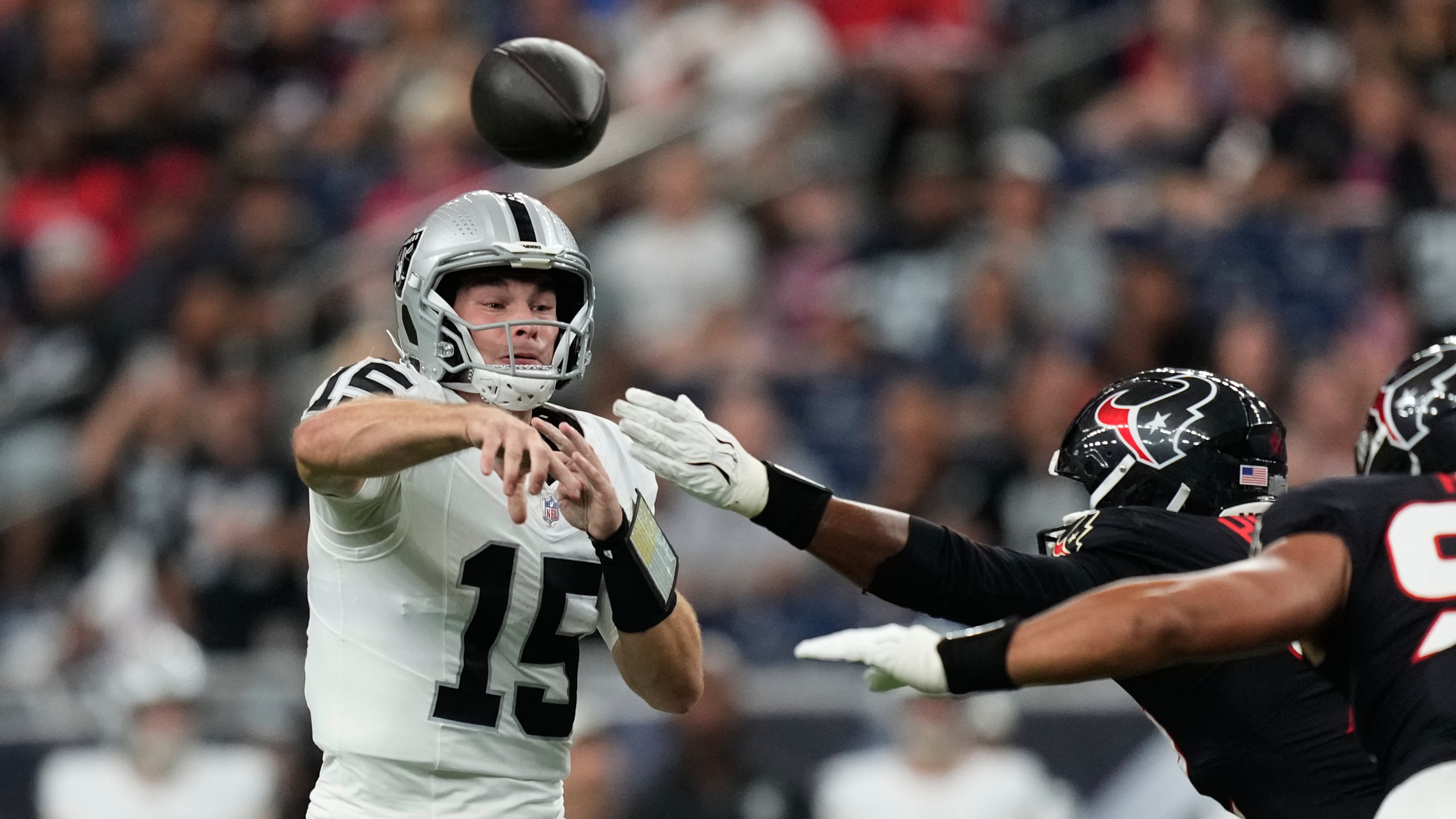 Las Vegas Raiders quarterback Fernando Mendoza (15) throws against the Houston Texans while under pressure during the first half of an NFL preseason football game, Thursday, Aug. 20, 2026, in Houston. (AP Photo/Ashley Landis)