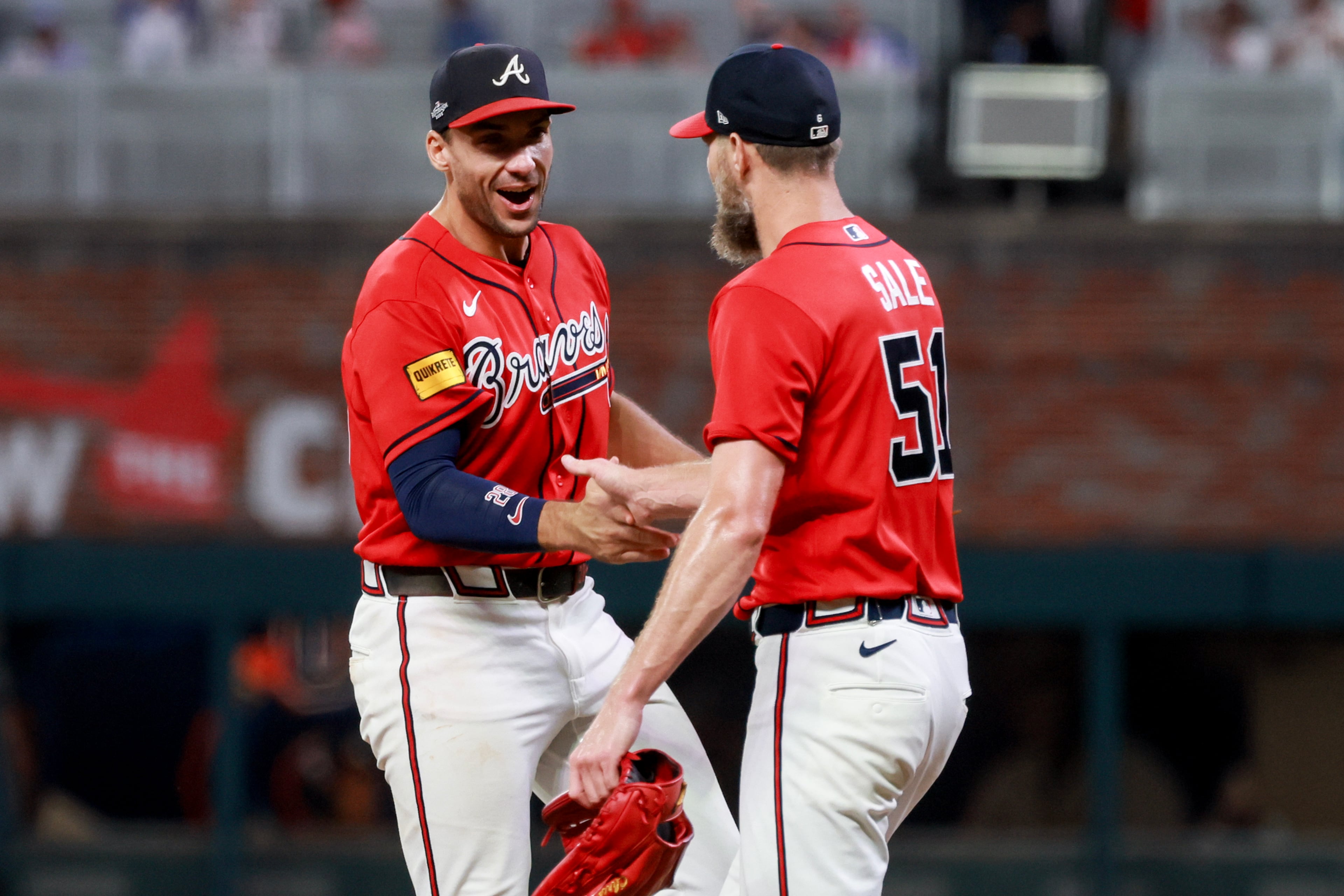 Atlanta Braves first baseman Matt Olson (28) celebrates with pitcher Chris Sale (51) after defeating the Philadelphia Phillies in the ninth inning of Game 3 to win an MLB National League Wild Card playoff series between the Atlanta Braves and the Philadelphia Phillies, Thursday, Oct. 1, 2026, in Atlanta. (Jason Getz/AJC)