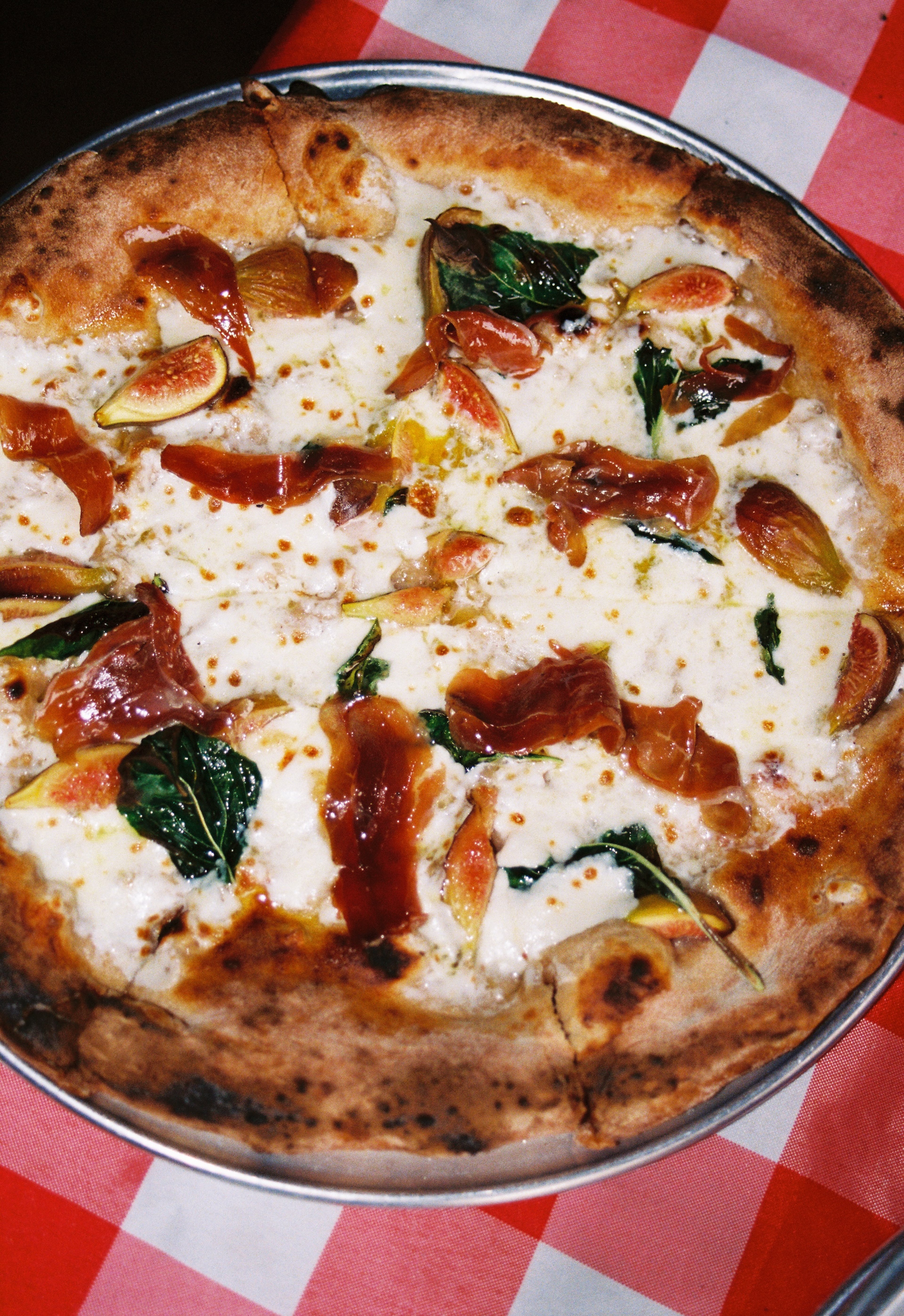 Phantom Pizza's fig and duck pizza with mozzarella, basil, fig and duck prosciutto. (Courtesy of Jae Shin Cross)