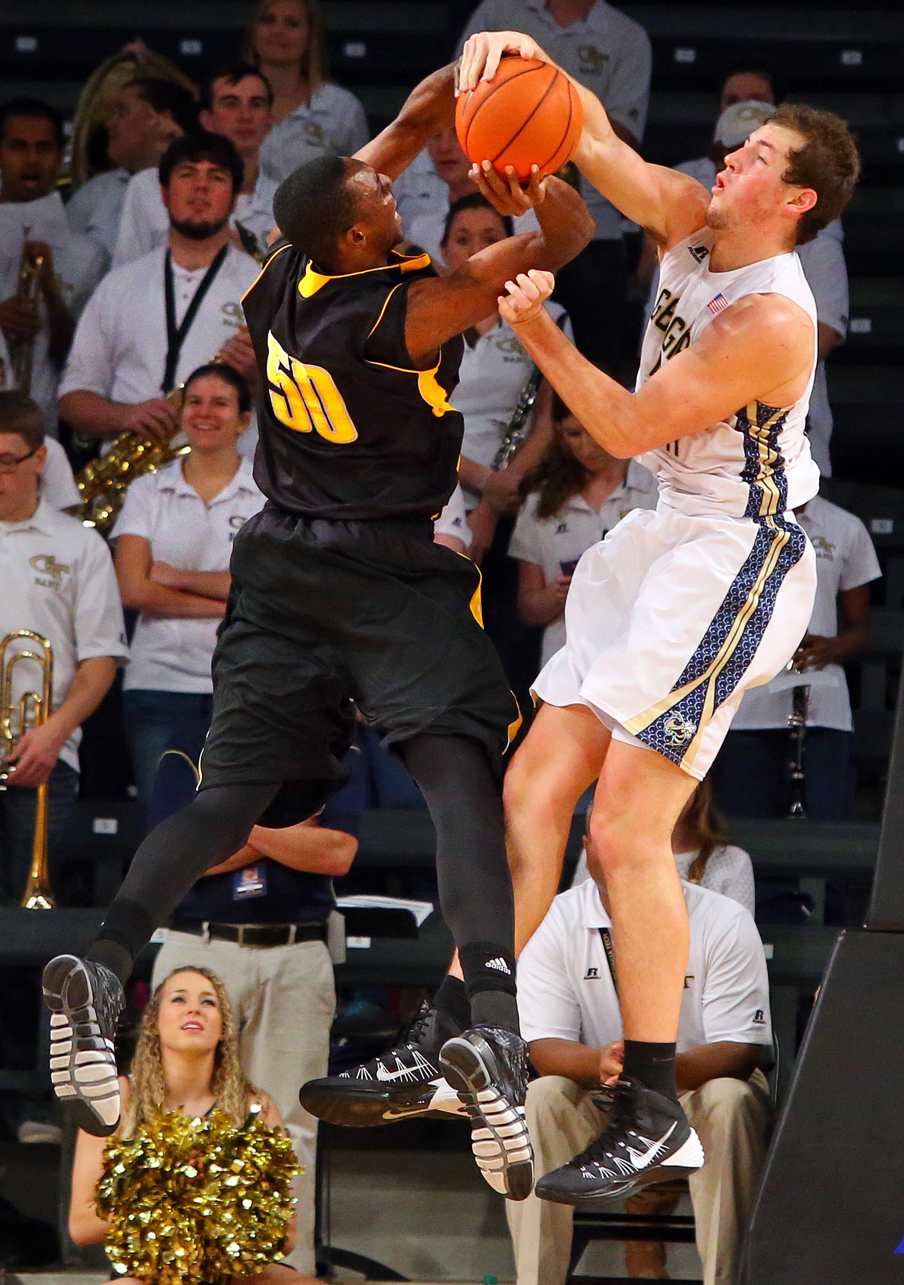 Georgia Tech center Daniel Miller blocks a shot by Kennesaw State center Willy Kouassi during the second half of a college basketball game on Monday, Dec. 16, 2013, in Atlanta.