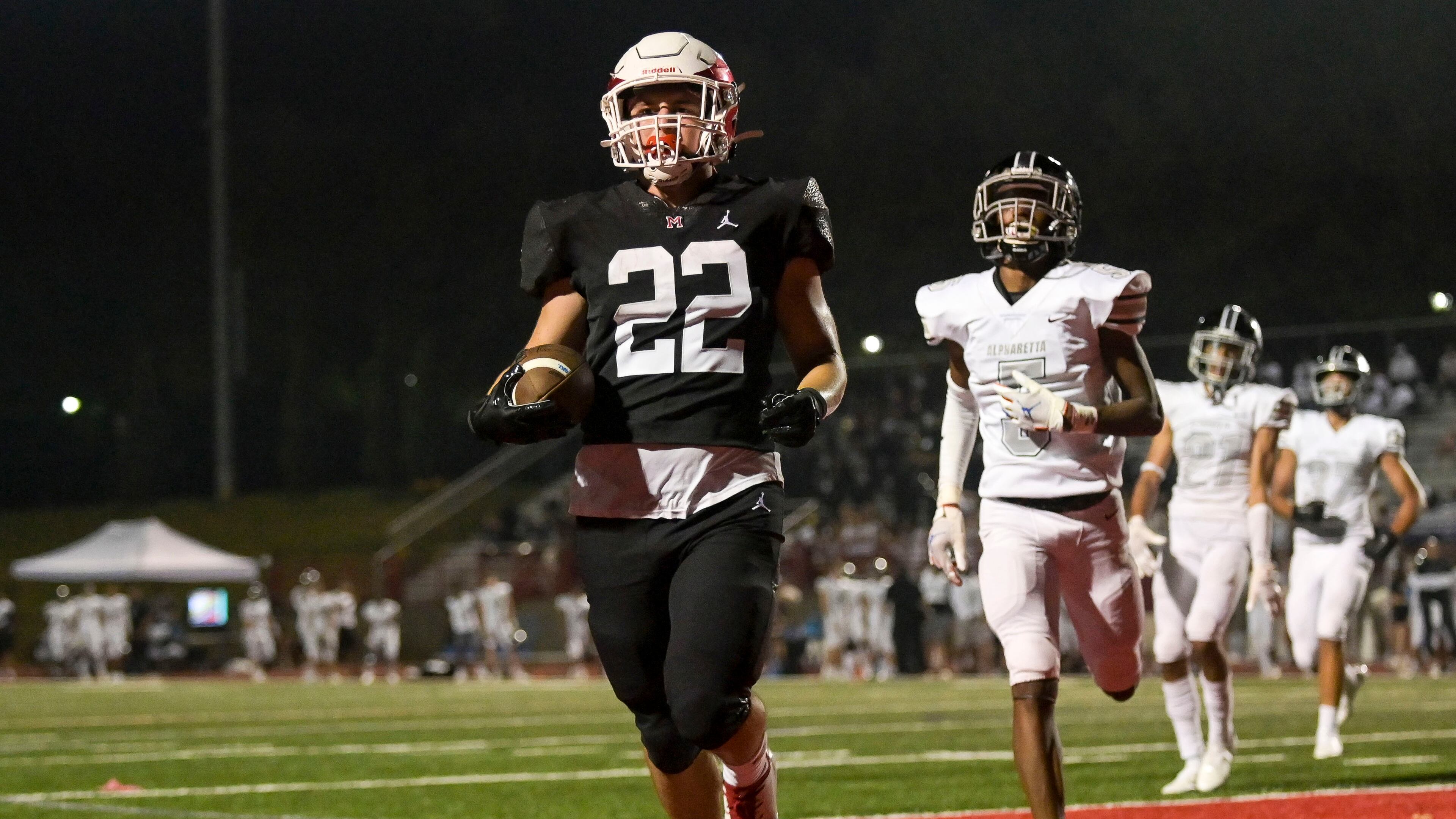 Milton running back Scott Moskowitz (22) reaches the end zone for a touchdown in the second half of Friday's 55-27 victory over Alpharetta. (Daniel Varnado/Special to the AJC