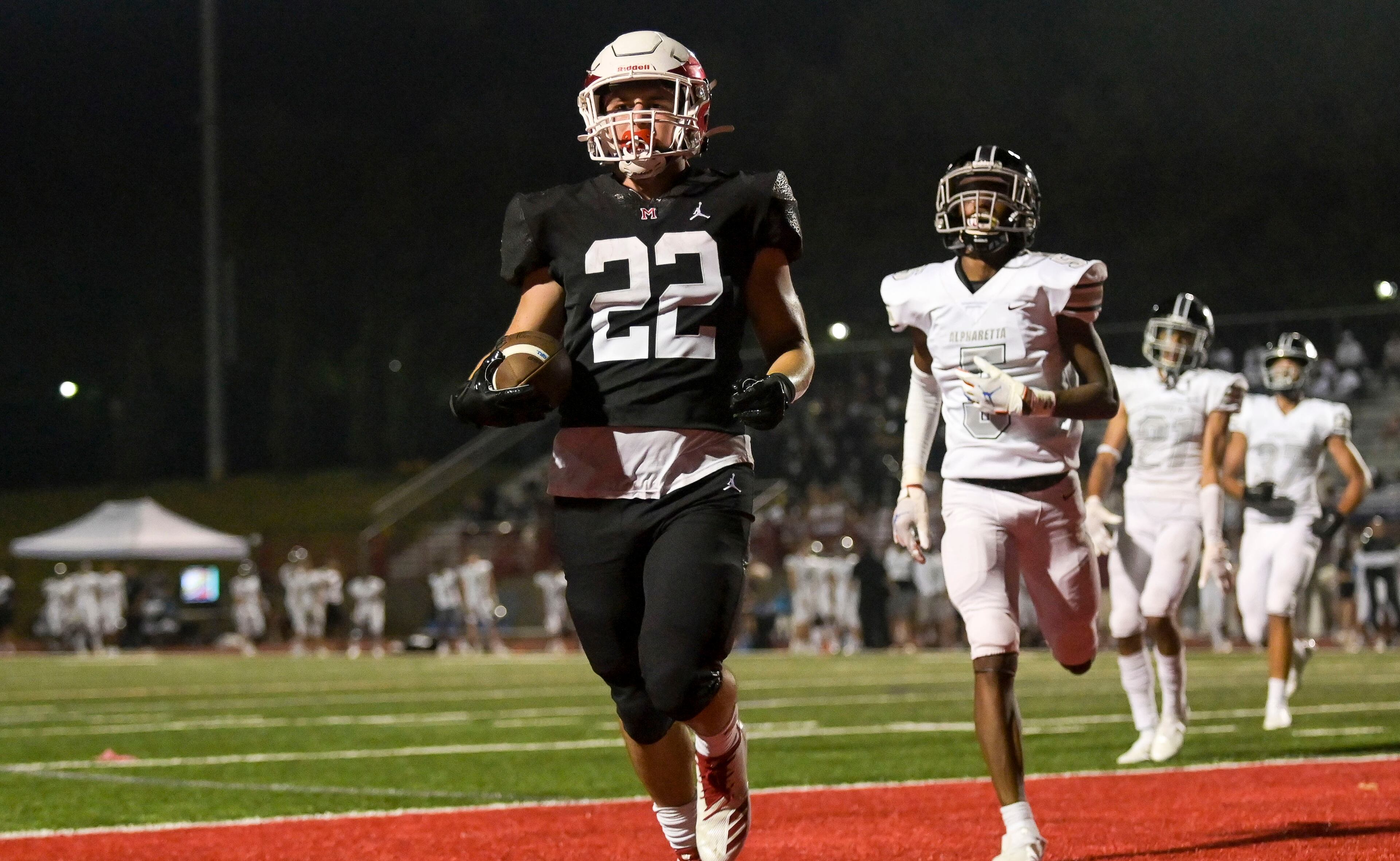Milton running back Scott Moskowitz (22) reaches the end zone for a touchdown in the second half of Friday's 55-27 victory over Alpharetta. (Daniel Varnado/Special to the AJC