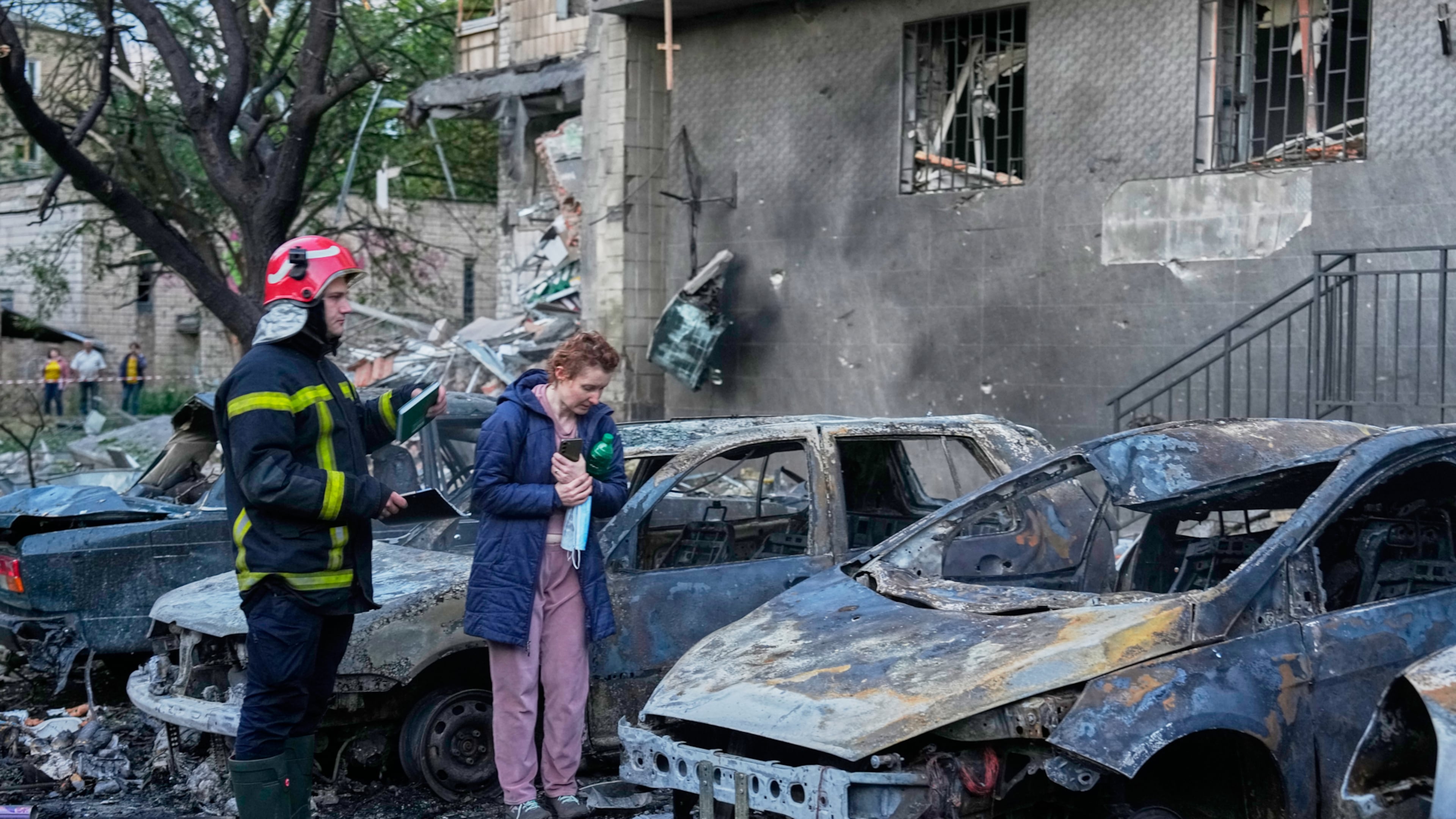An owner looks at her damaged car following a Russia missile attack in Kyiv, Ukraine, Sunday, July 19, 2026. (AP Photo/Efrem Lukatsky)