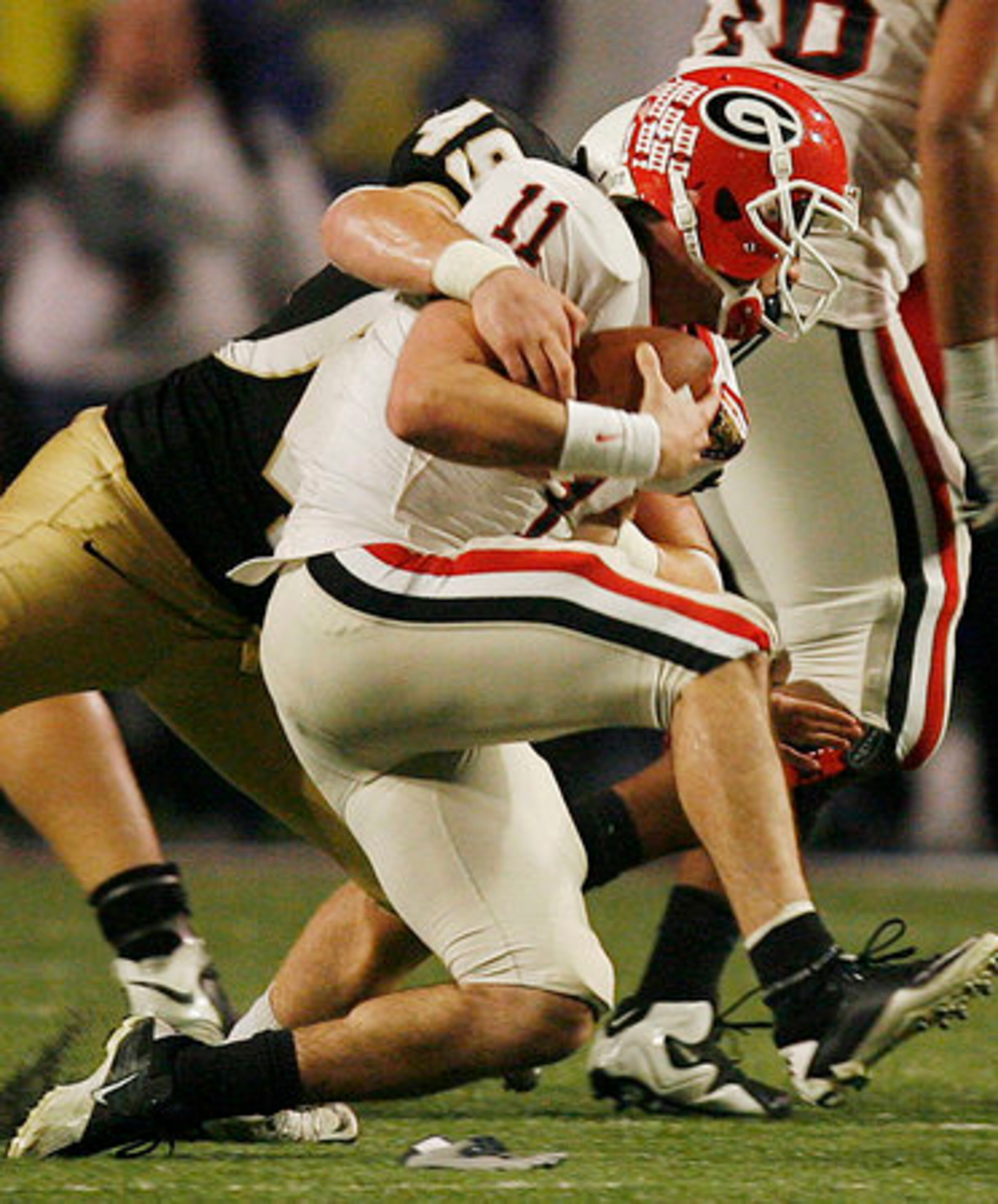 Georgia quarterback Aaron Murray (11) is sacked by University of Central Florida defensive end Bruce Miller (49) during the Liberty Bowl in Memphis, Tennessee, Friday, December 31, 2010. UCF defeated Georgia, 10-6.