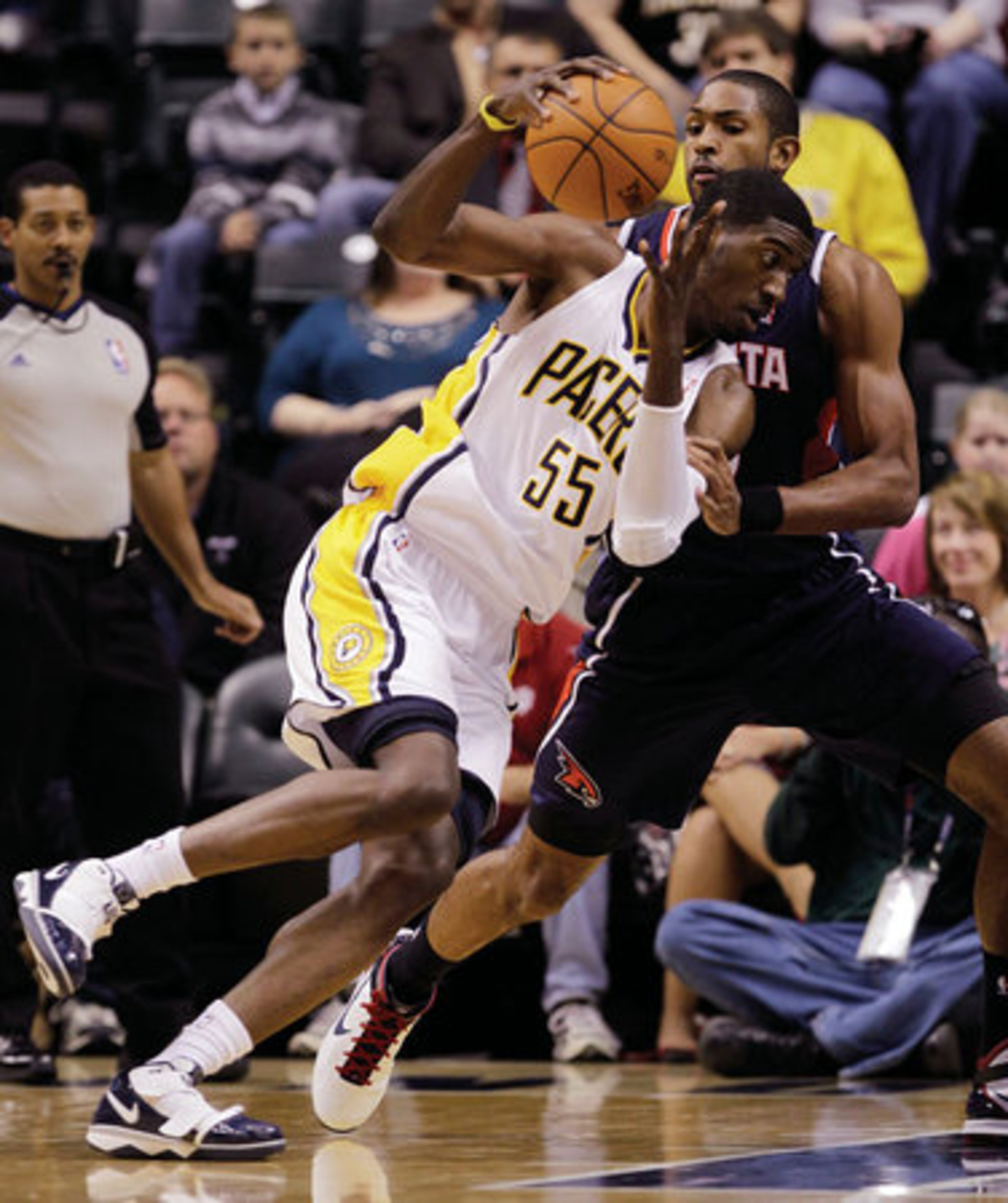 Indiana Pacers center Roy Hibbert, front, backs down Atlanta Hawks center Al Horford, of the Dominican Republic, in the first half of an NBA basketball game in Indianapolis, Tuesday, Nov. 16, 2010.