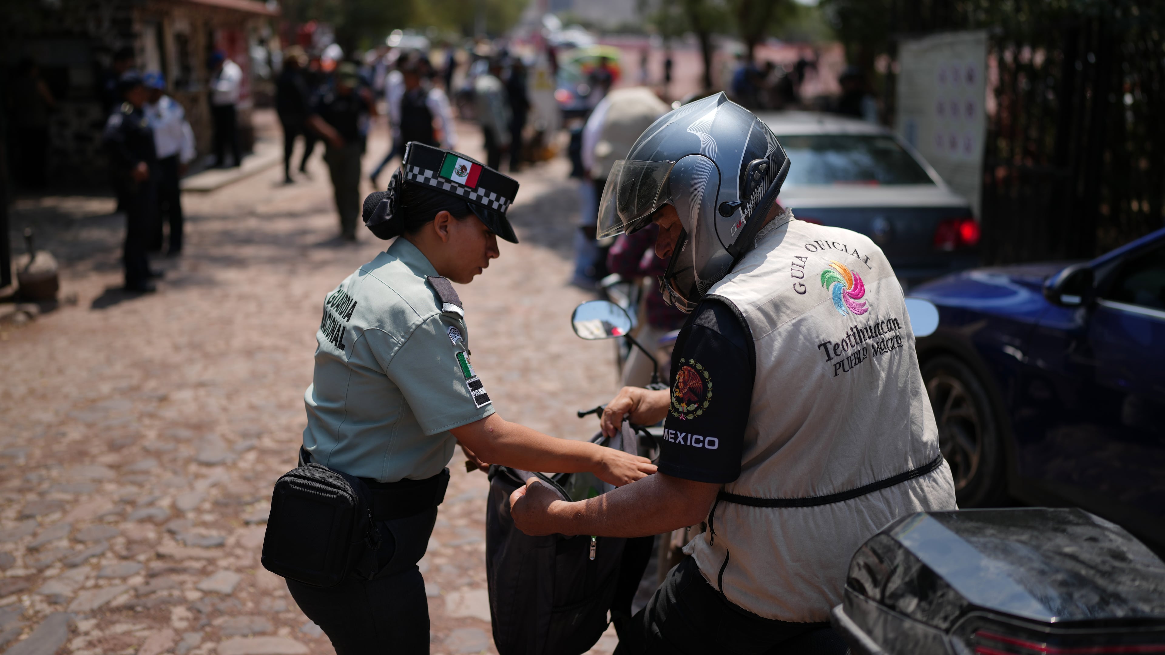 Police search visitors at the Teotihuacan pyramids as the archaeological site reopened two days after a gunman opened fire killing a Canadian tourists, outside Mexico City, Wednesday, April 22, 2026. (AP Photo/Eduardo Verdugo)
