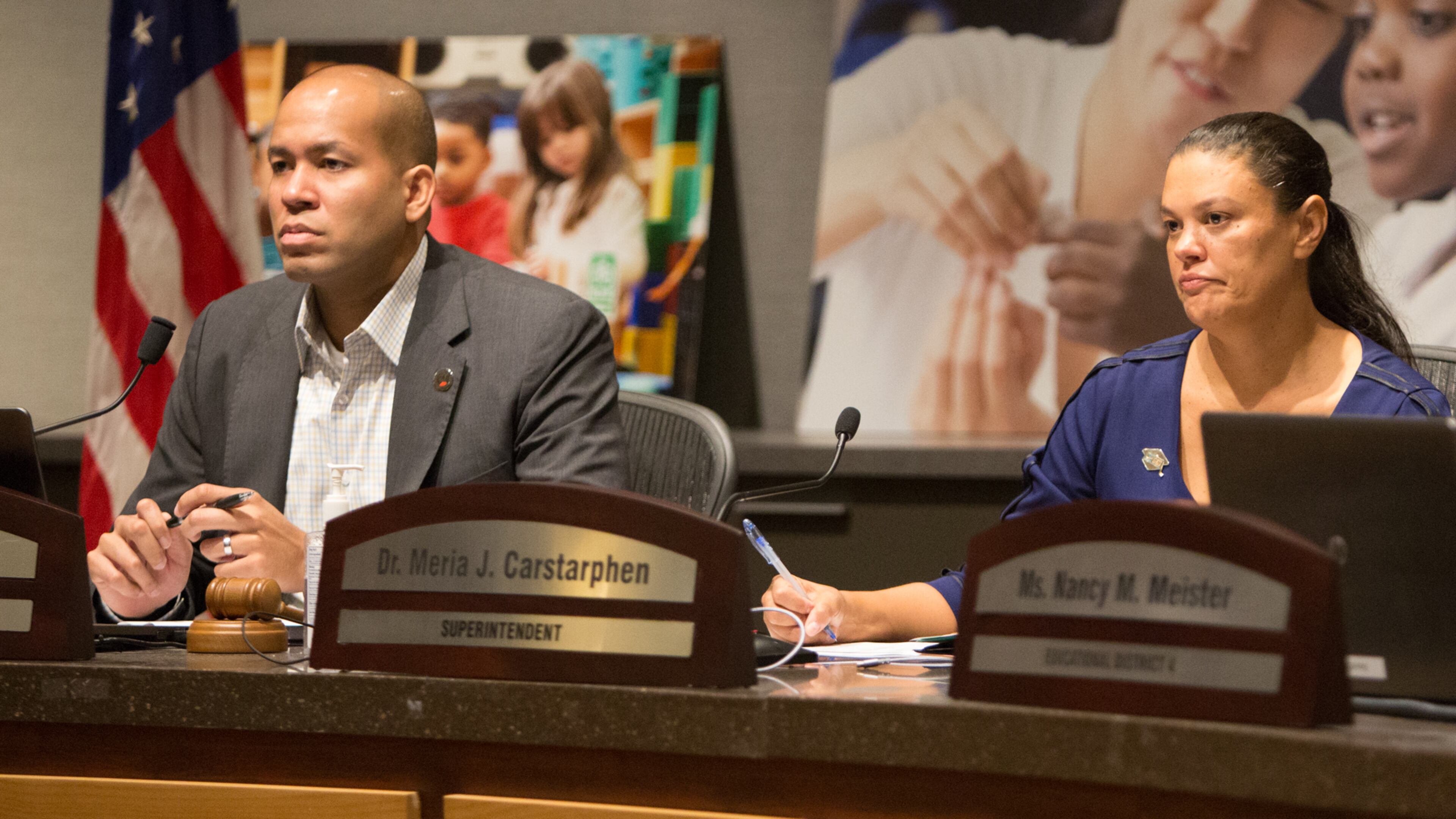 The Atlanta school board chairman Jason Esteves(left) & superintendent Meria Carstarphen's listen to public comment during a special meeting to discuss whether to extend Carstarphen's contract. (Photo by Phil Skinner).