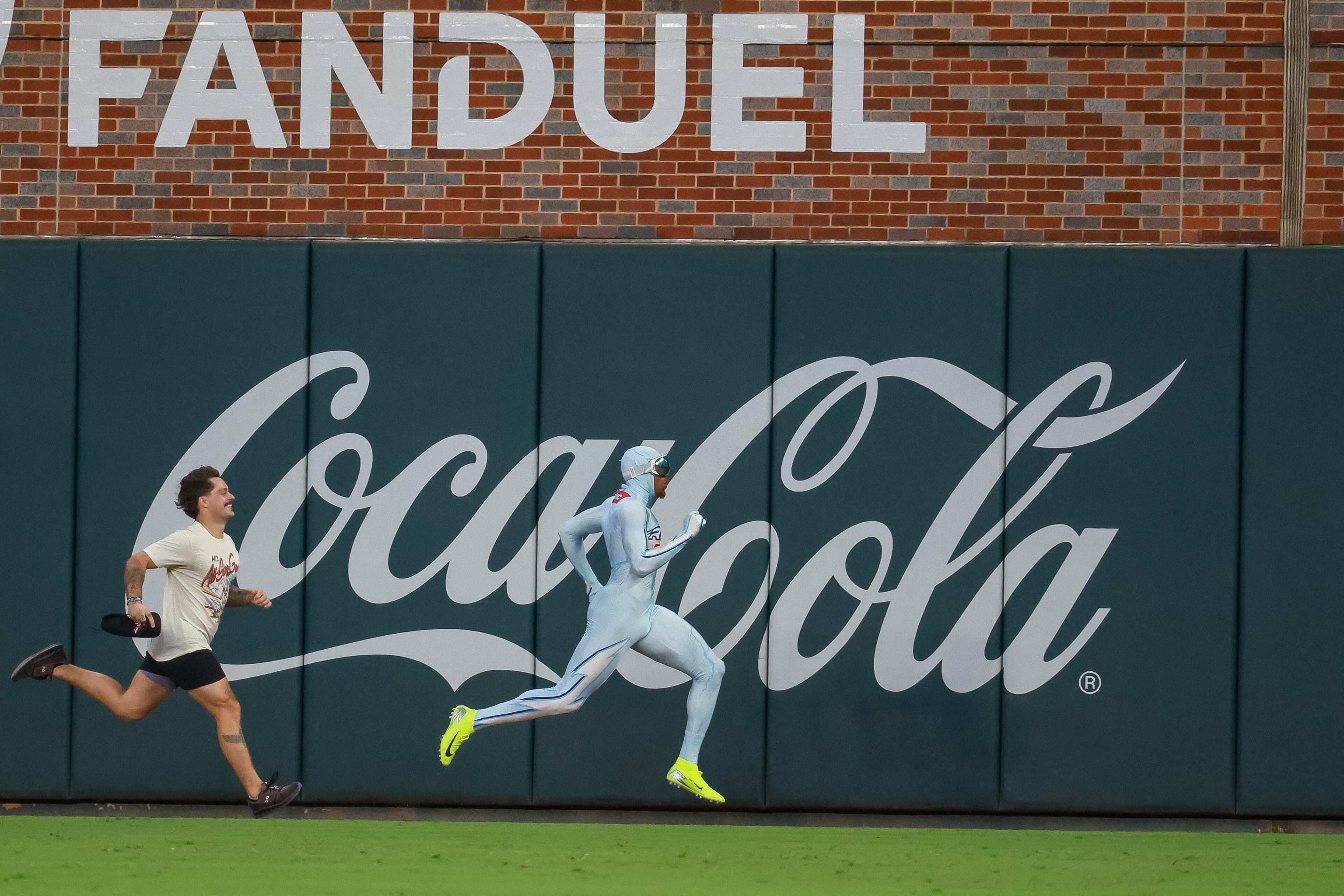 The Atlanta Braves racer "The Freeze" passes a competitor between innings of the MLB All-Star Game at Truist Park in Atlanta on Tuesday, July 15, 2025. (Jason Getz/AJC)