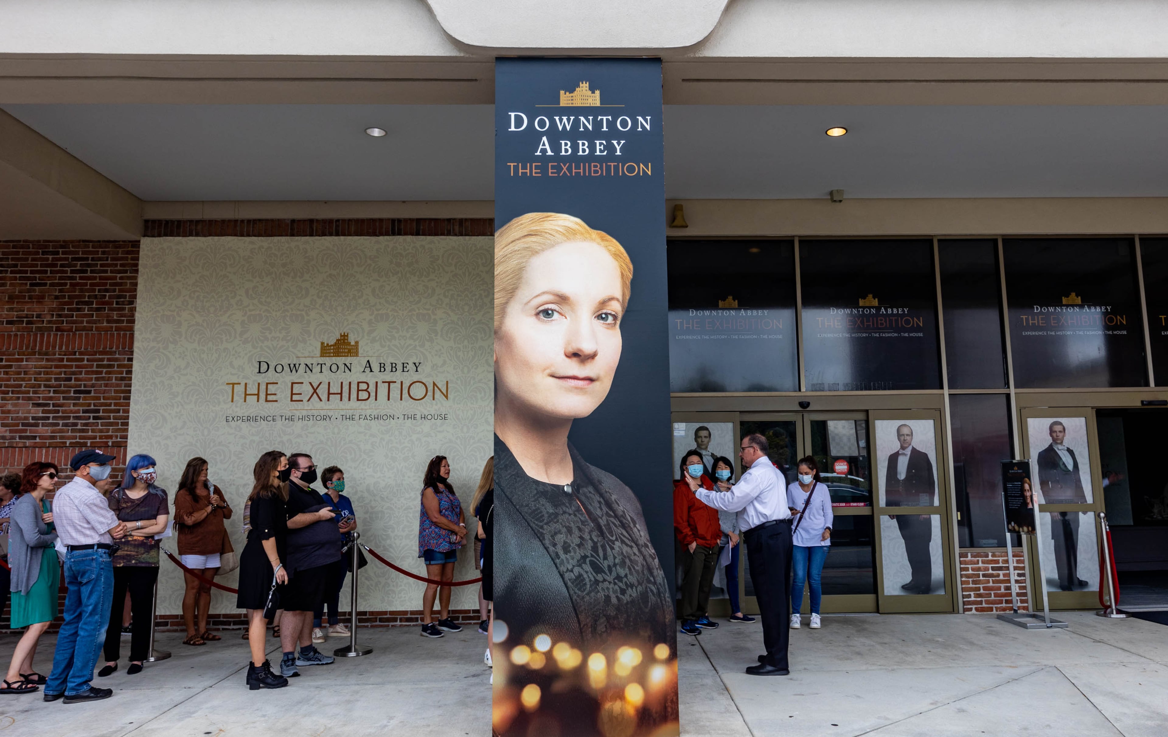 In line to see the show, patrons of Downton Abbey: The Exhibition wait in Sandy Springs for doors to open at the experiential, traveling show Saturday, Oct 2, 2021. The presentation in Atlanta is the largest showing on the national tour with two additional rooms on display from the television series' film set, as well as more fashion shown that was used in the PBS show and prop artifacts from the iconic house. (Jenni Girtman for The Atlanta Journal-Constitution)