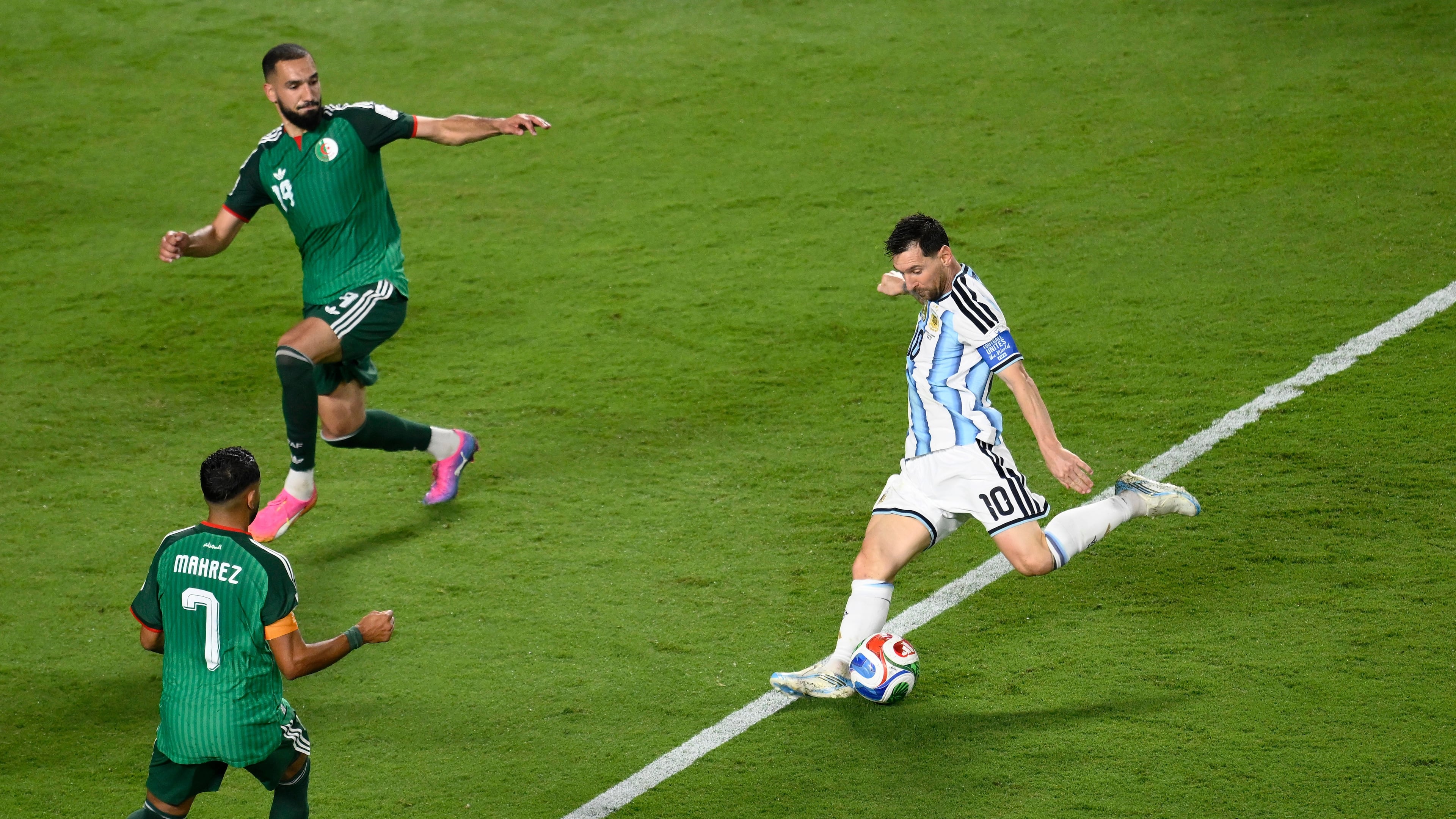 Argentina's Lionel Messi (10) shoots and scores their third goal against Algeria's Riyad Mahrez (7) and Nabil Bentaleb (19) during the World Cup Group J soccer match between Argentina and Algeria in Kansas City, Mo., Tuesday, June 16, 2026. (AP Photo/Reed Hoffmann)