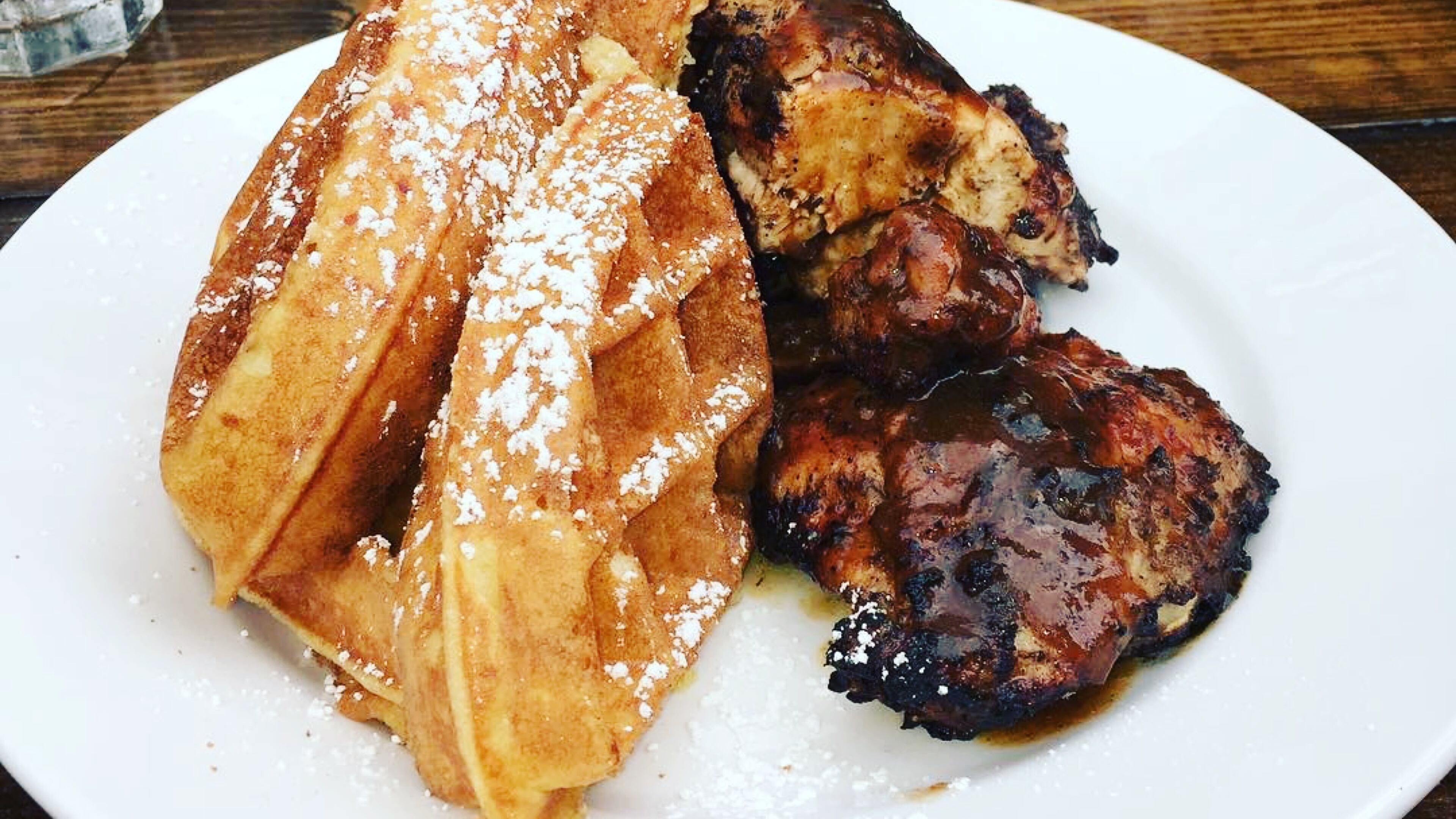 When Jamaican flavors meet Southern fare at Negril Village, guests get a plate of jerk chicken and waffles. / CONTRIBUTED BY: Negril Village Atlanta.
