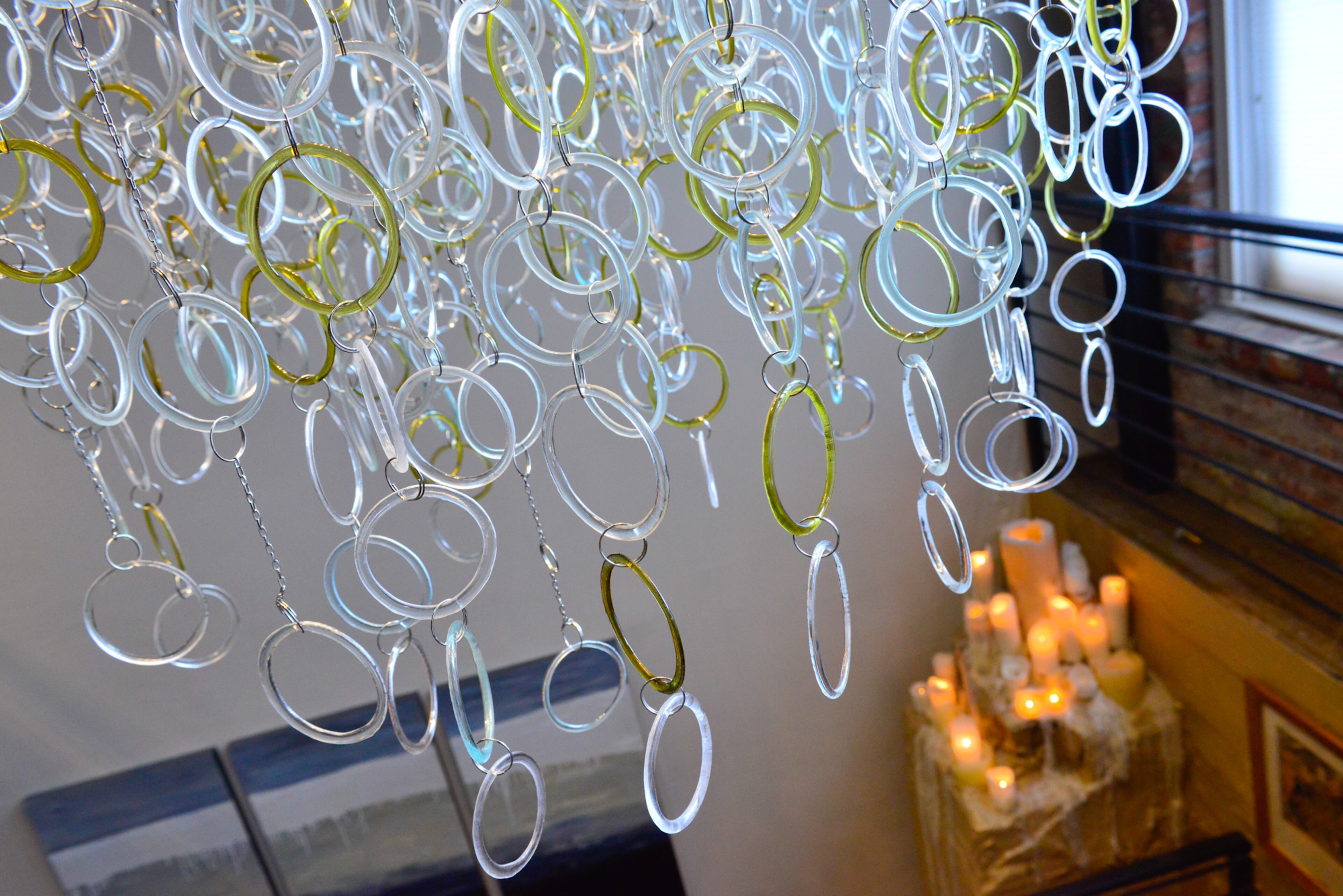 Recycled glass is used for the new chandelier that fills the stairwell of Thomas and Betsy Walsh's unit in Atlanta's Factory Lofts. Kathleen Plate of Smart Glass, also known for her recycled glass jewelry, created the chandelier, which Betsy Walsh describes as a piece of art that happens to be a light fixture.