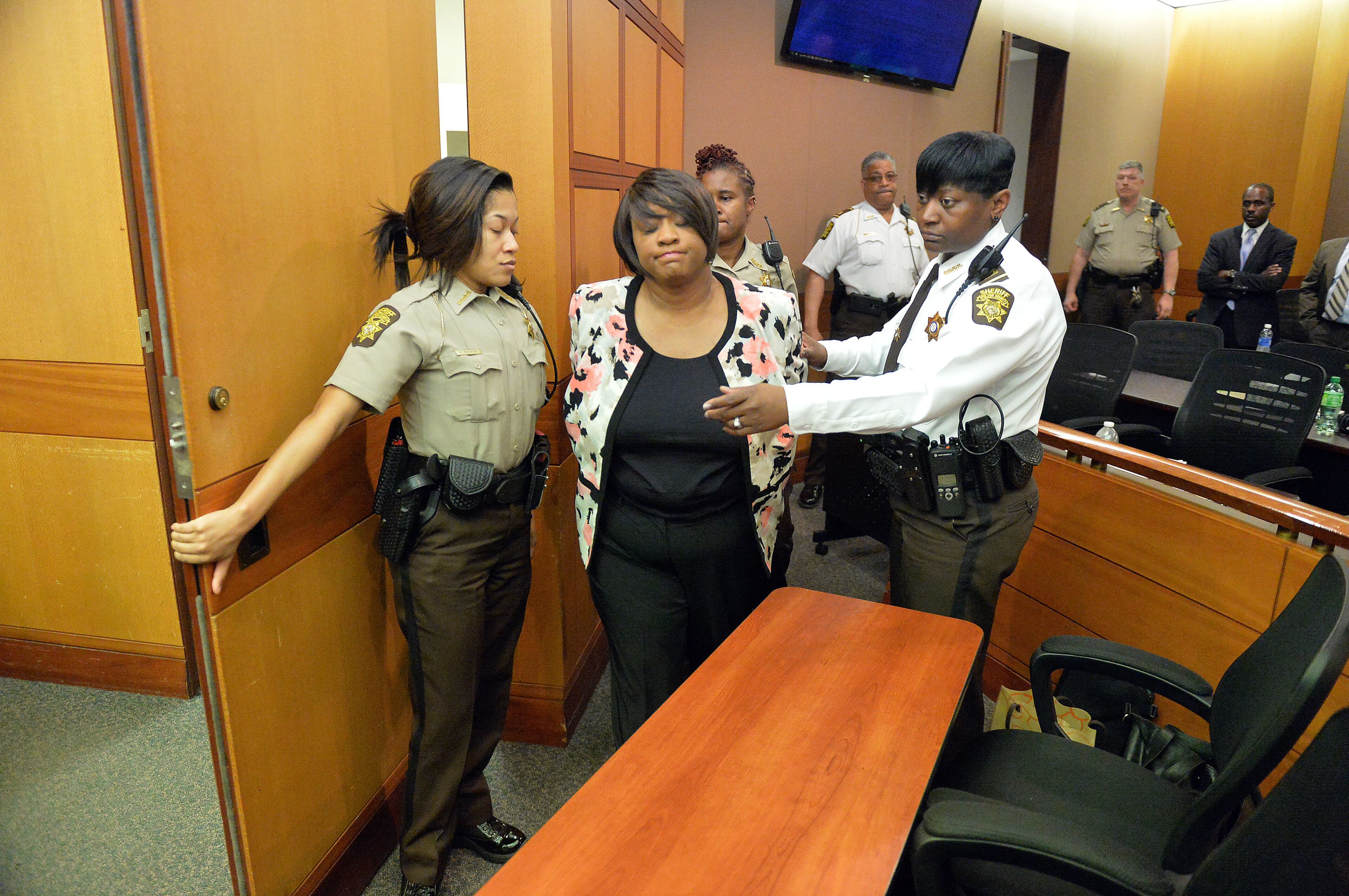 Former APS SRT Director Tamara Cotman is led to a holding cell after a jury convicted her of Violation of Racketeer Influenced and Corrupt Organizations Act Wednesday. A jury of six men and six women rendered their verdicts on the eighth day of deliberations in the Atlanta Public Schools test-cheating trial on Wednesday, April 1, 2015. Jurors sorted through roughly five months of testimony against 12 former educators accused of engaging in a racketeering conspiracy to inflate test scores. (Atlanta Journal-Constitution, Kent D. Johnson, Pool)