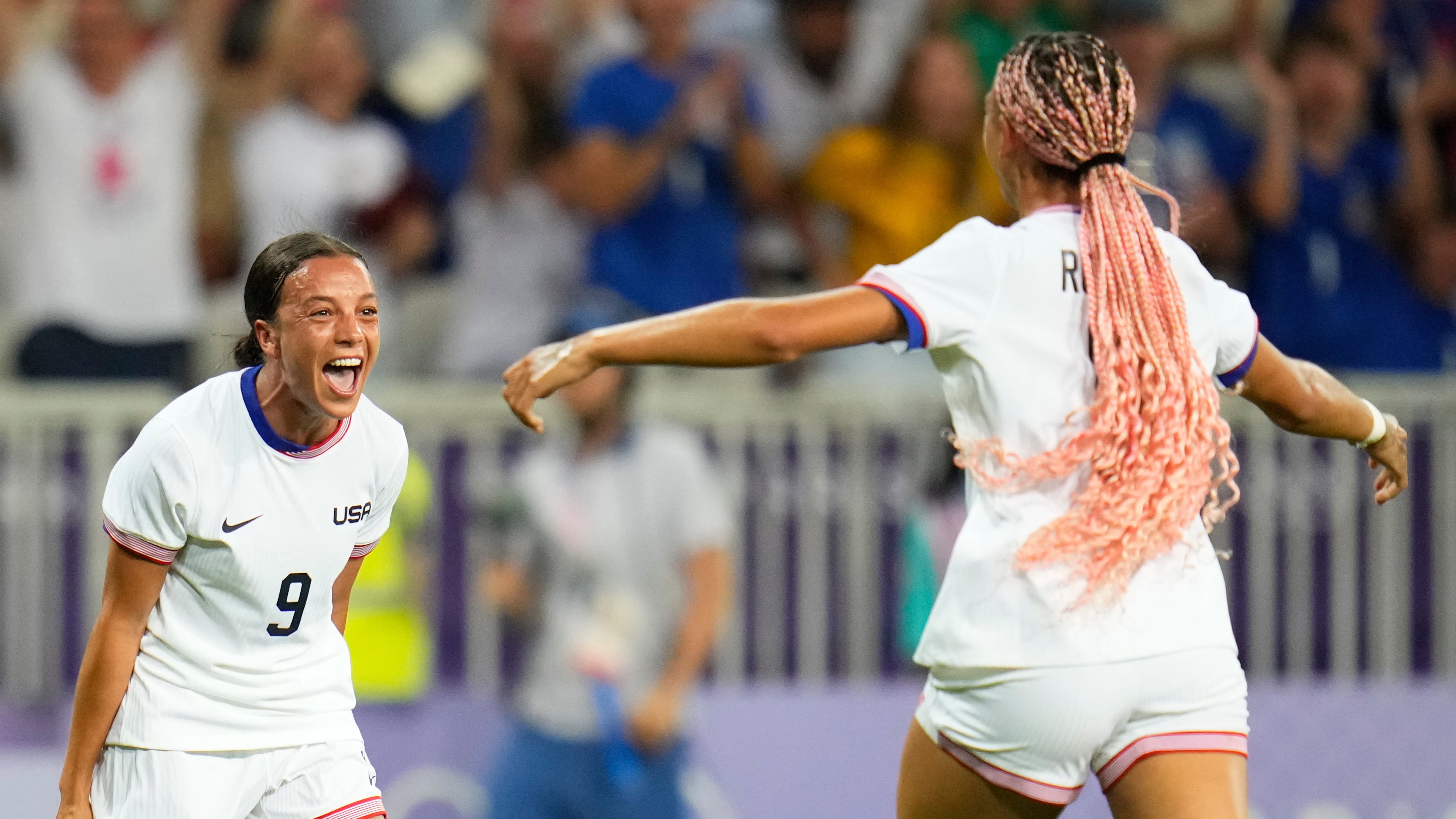 FILE - United States' Mallory Swanson, left, reacts after teammate Trinity Rodman, right, scored a goal during a women's group B match between the United States and Zambia at Nice Stadium at the 2024 Summer Olympics, July 25, 2024, in Nice, France. (AP Photo/Julio Cortez, File)