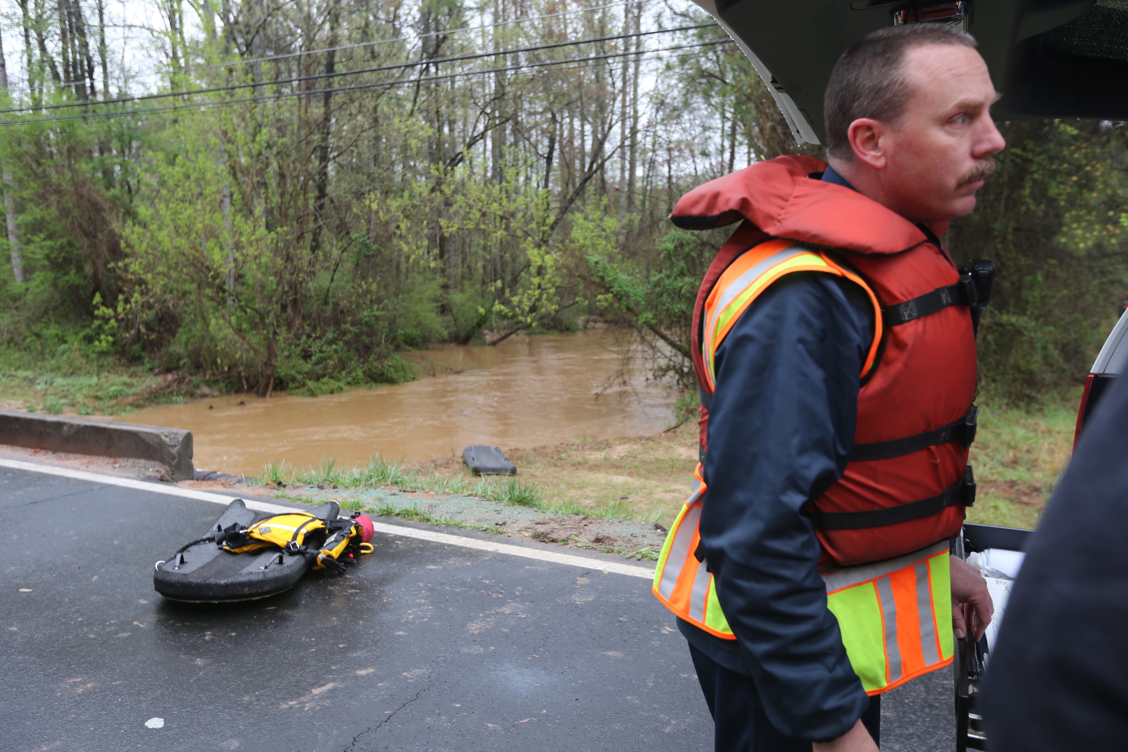 Gwinnett County police and firefighters are searching rain-swollen Jackson Creek near Lilburn for a car that reportedly ran off Harbins Road into the creek, Gwinnett police spokesman Ed Ritter said