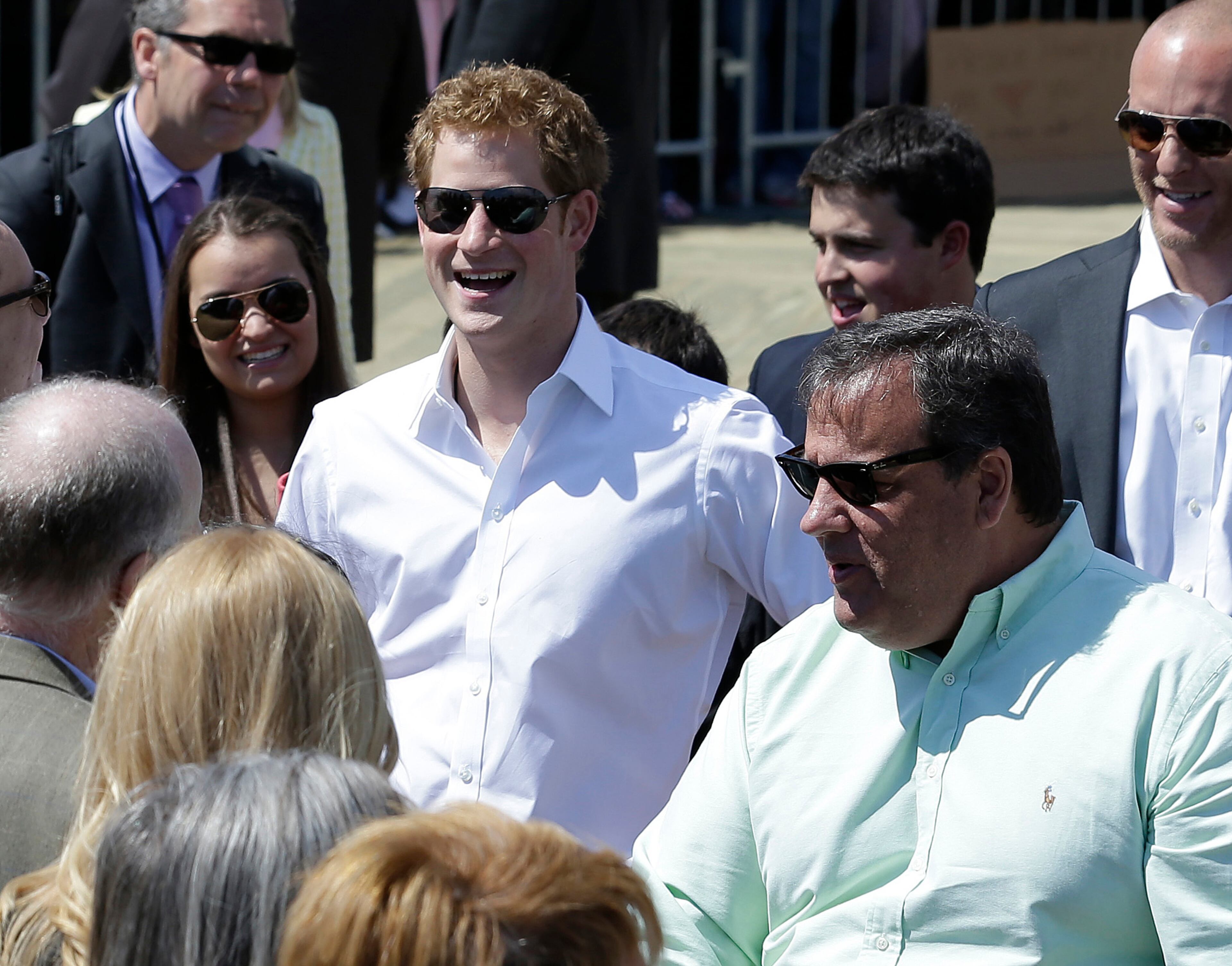 Britain's Prince Harry, center, reacts while standing with New Jersey Gov. Chris Christie at Casino Pier during a tour of the area hit by Superstorm Sandy, Tuesday, May 14, 2013, in Seaside Heights, N.J. The prince toured the community's rebuilt boardwalk, which is about two-thirds complete. New Jersey sustained about $37 billion worth of damage from the storm. (AP Photo/Julio Cortez)