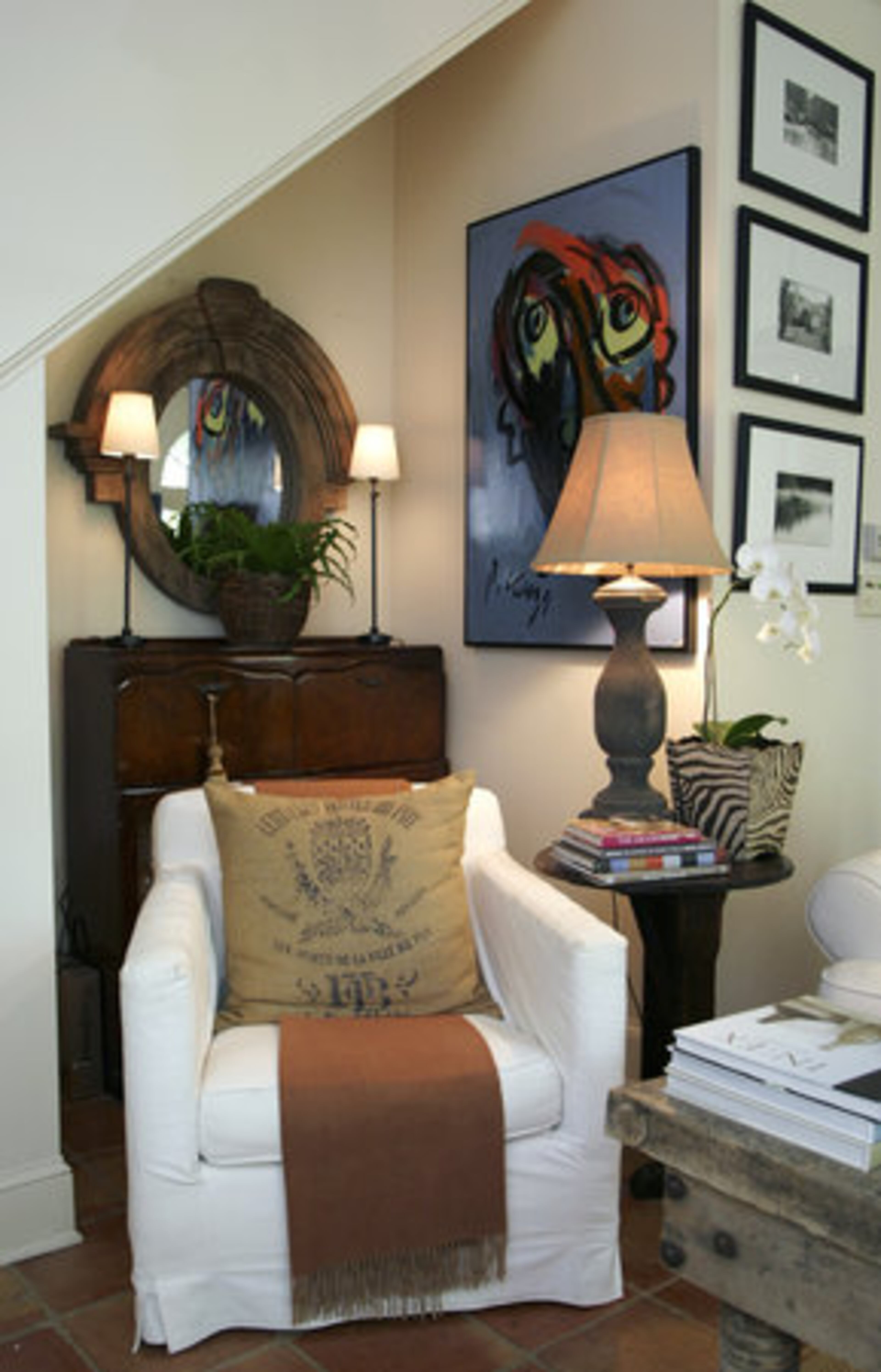 The wet bar tucked in a nook in the living room is one of Robert's favorite pieces. Throughout the home Mary uses linen grain sacks sourced from Germany, France and South America to make toss pillows.
