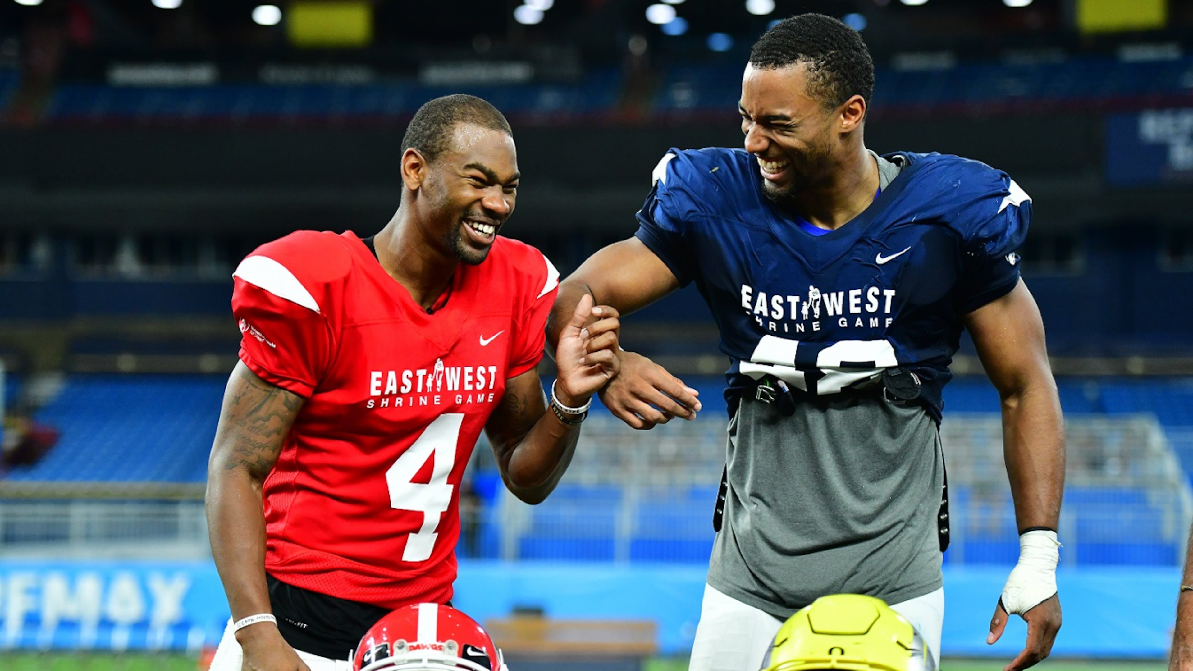 Terry Godwin II #4 from Georgia and Justin Hollins #48 from Oregon joke around before accepting the offensive and defensive MVP honors at the 2019 East-West Shrine Game at Tropicana Field on January 19, 2019 in St Petersburg, Florida. (Photo by Julio Aguilar/Getty Images)