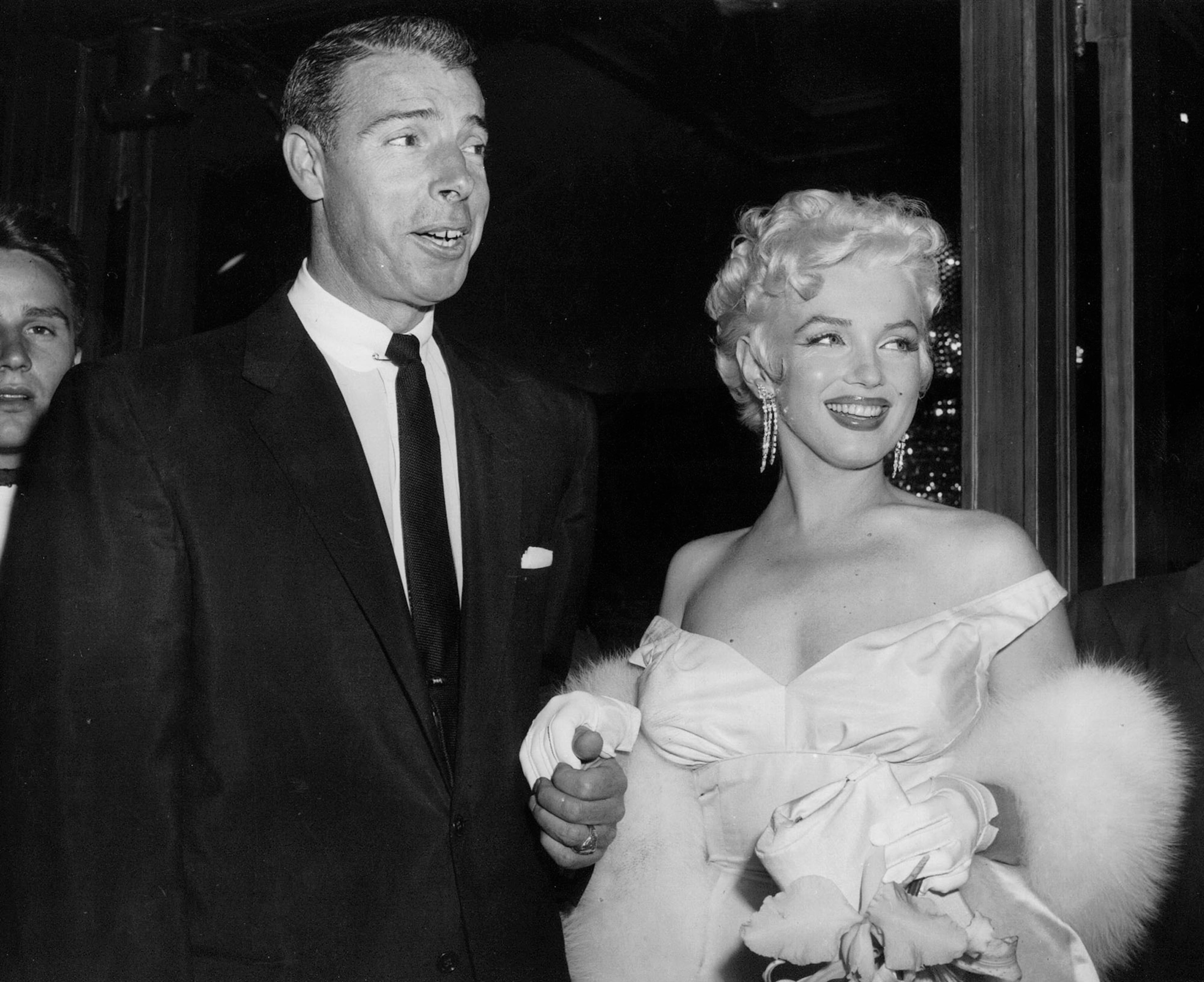 In this June 2, 1955, file photo, actress Marilyn Monroe, right, dressed in a glamorous evening gown, arrives with Joe DiMaggio at the theater. Monroe's Lost Archives are coming to light now, along with a cache of other Monroe memorabilia that the Beverly Hills auction house Julien's is putting up for sale on Dec. 5-6, 2014. Along with the letters from DiMaggio, Miller and such Hollywood luminaries as Cary Grant and Jane Russell are some of the actress' favorite clothes, photographs, paintings and other keepsakes. (AP Photo, File)