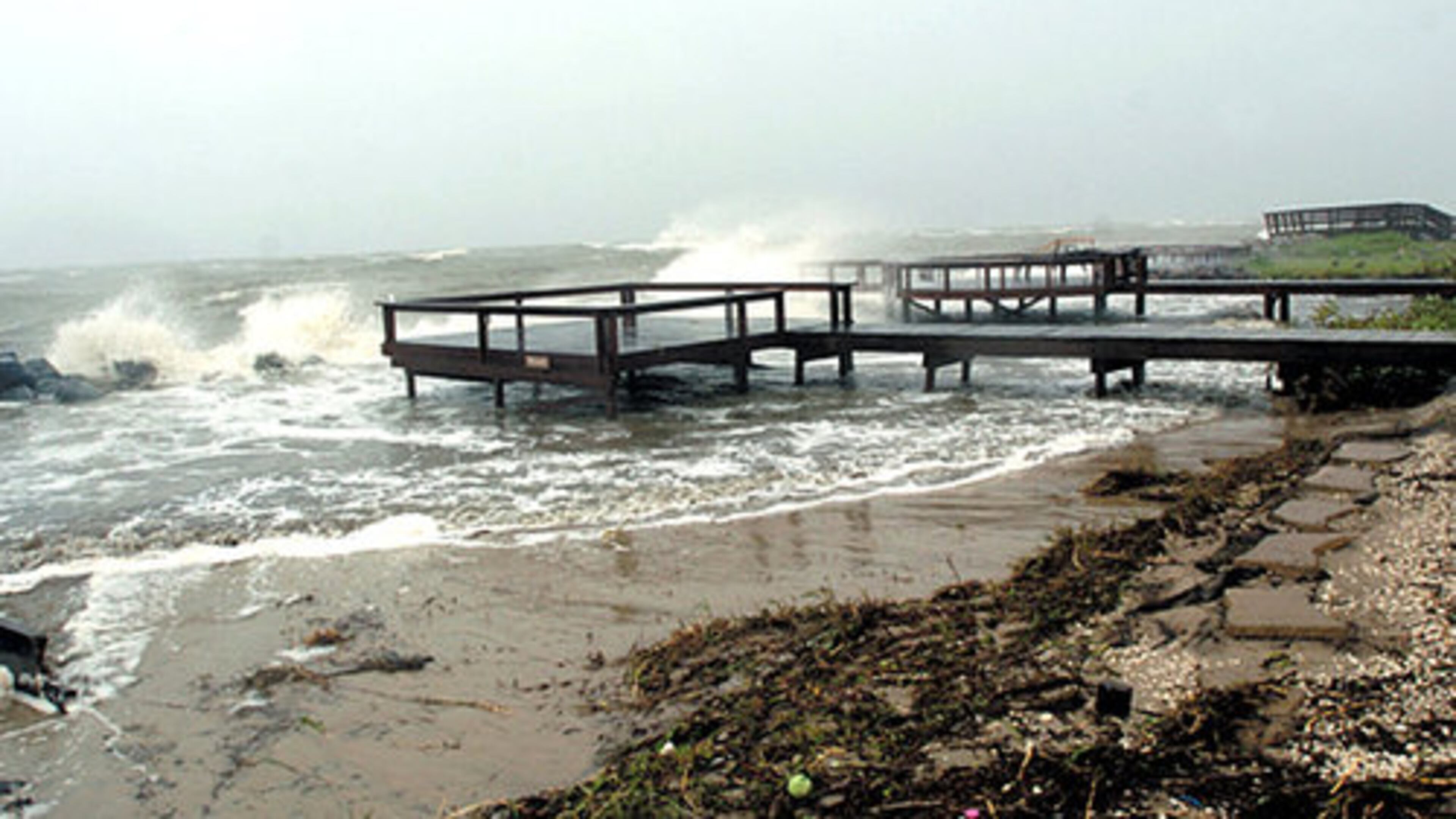 Waves crash over the rocks near St. Simons Island's Cedar Street beach access Friday. The Georgia Department of Natural Resources said numerous loggerhead turtle nests were washed away by the flooding.