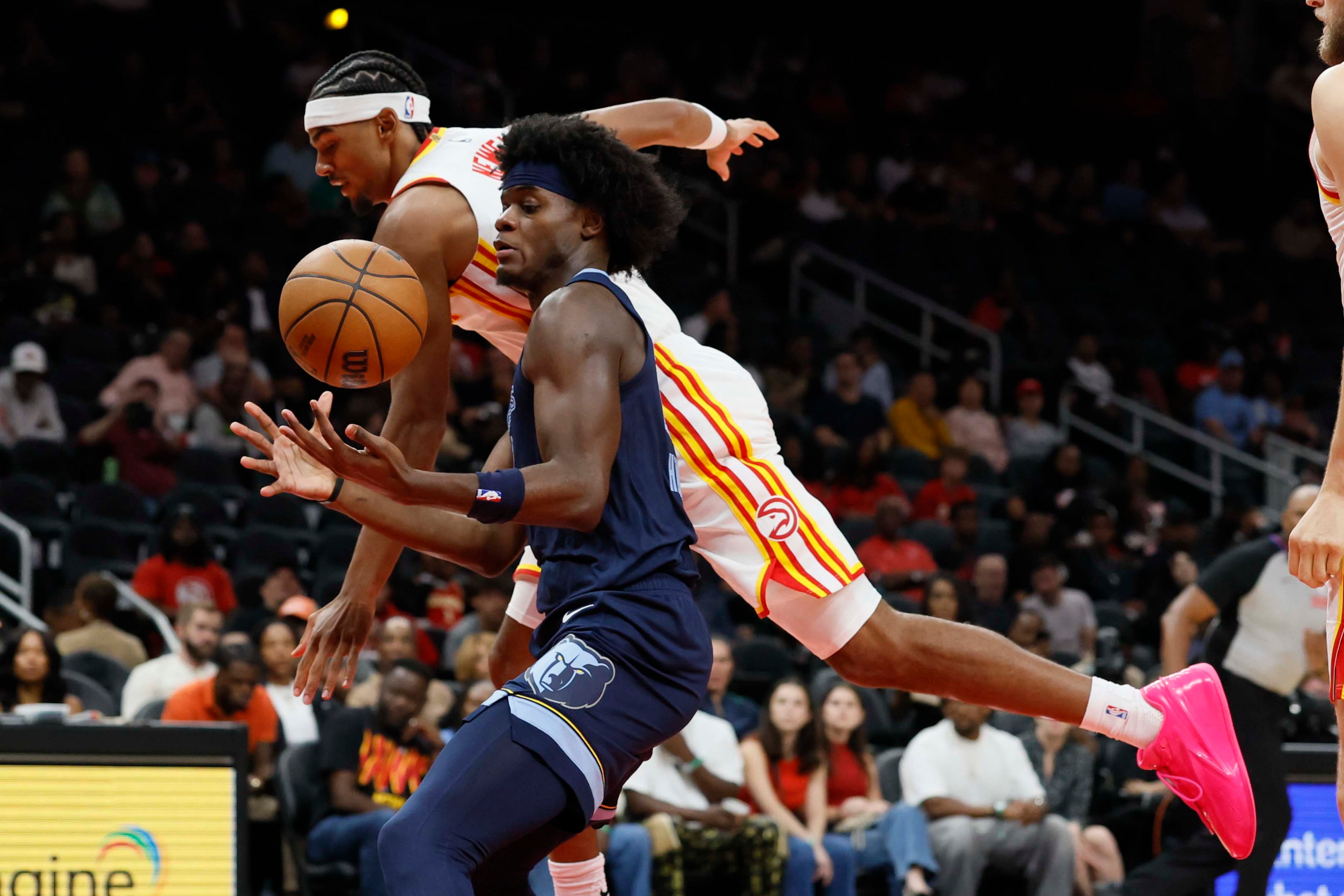 Atlanta Hawks forward Asa Newell battles for possession against Memphis Grizzlies forward Taylor Hendricks in the first half of a preseason NBA game at State Farm Arena in Atlanta on Monday, Oct. 5, 2026. (Miguel Martinez/AJC)