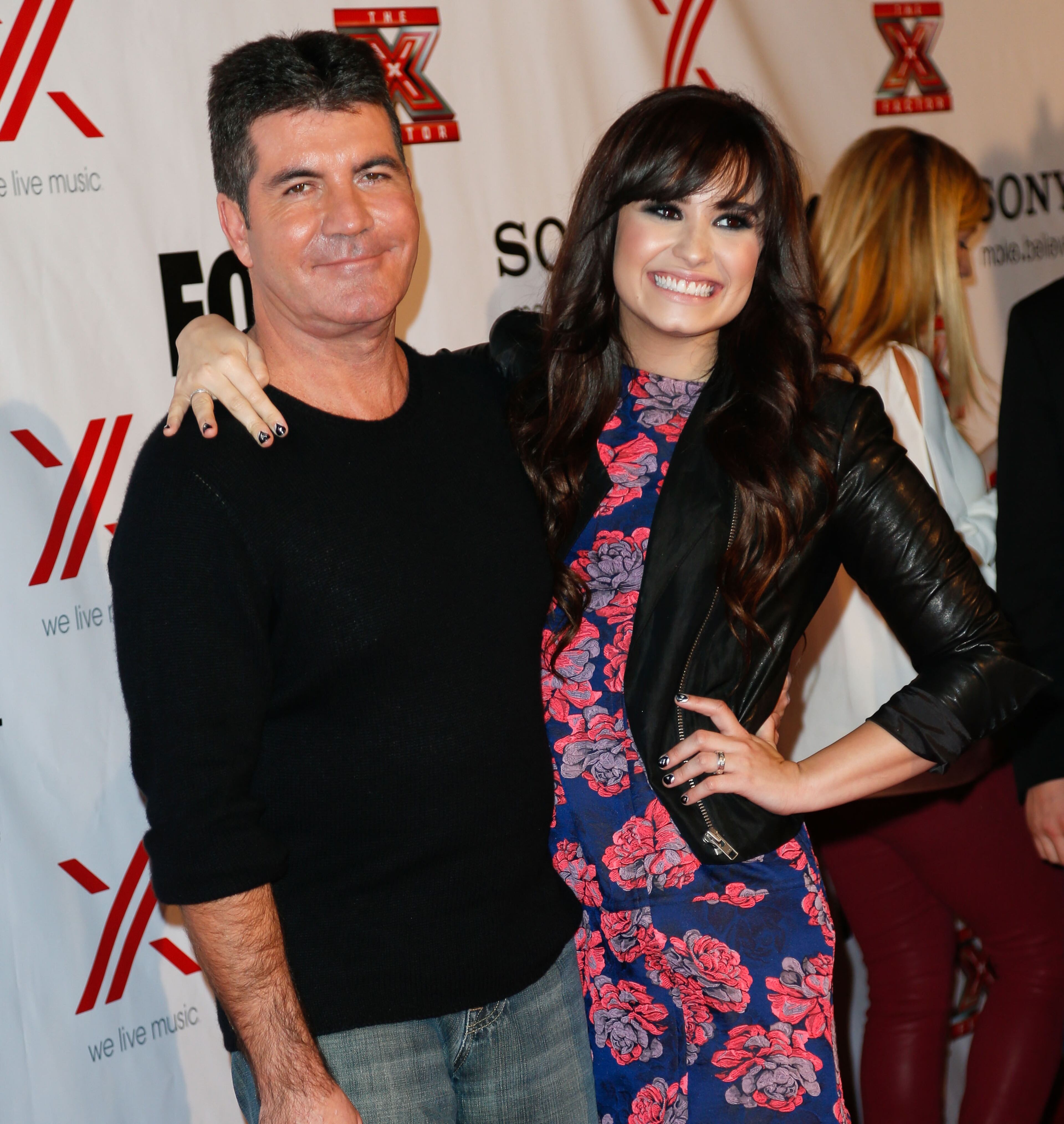 LOS ANGELES, CA - DECEMBER 06: Producer Simon Cowell (L) and singer Demi Lovato attend Fox's "The X Factor" viewing party at Mixology101 & Planet Dailies on December 6, 2012 in Los Angeles, California. (Photo by Imeh Akpanudosen/Getty Images)