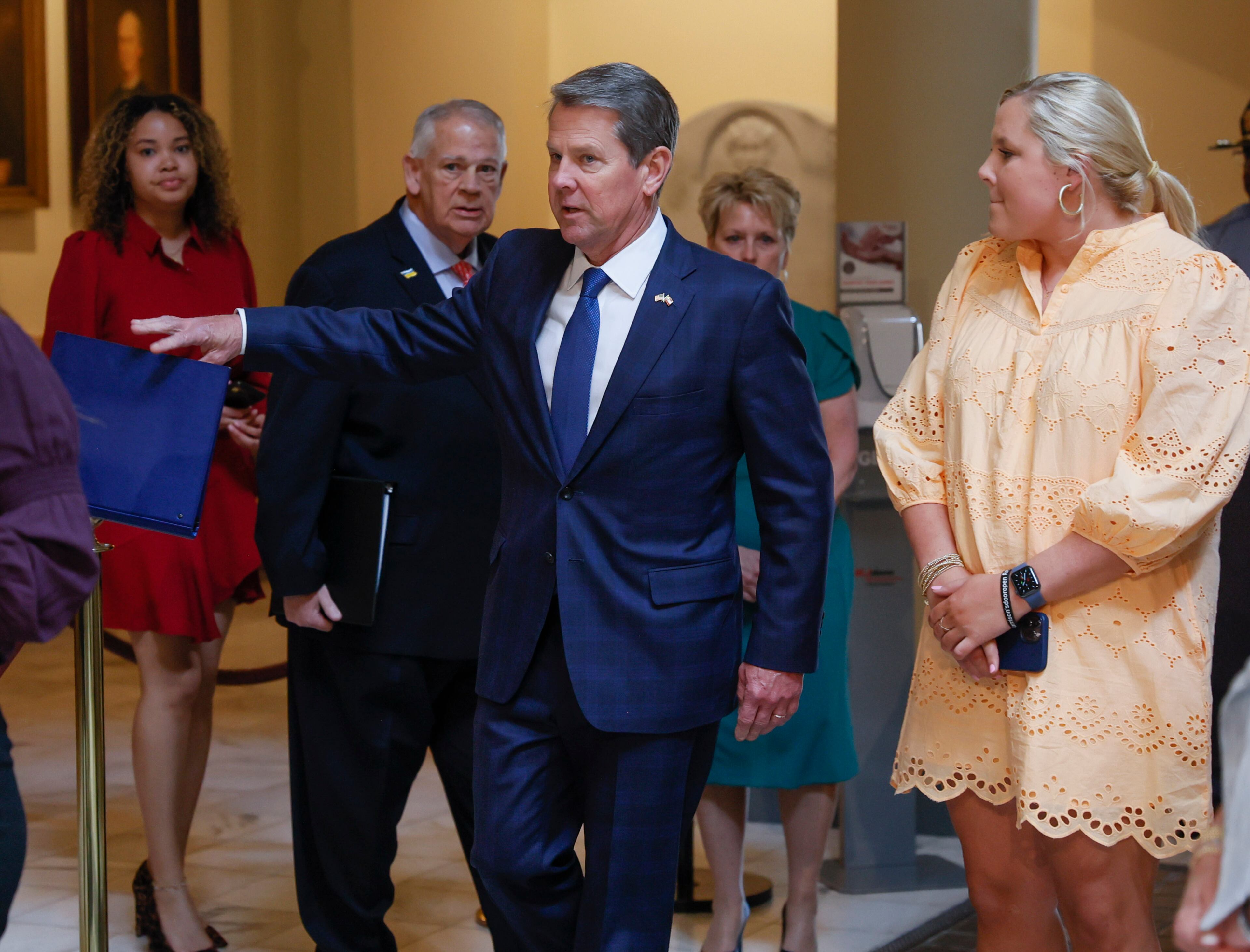 With his family and House Speaker David Ralston behind him, Gov. Brian Kemp heads from his office to sign House Bill 1013, which aims to increase access to mental health coverage in Georgia on Sine Die, the last day of the General Assembly, at the Georgia State Capitol in Atlanta on Monday, April 4, 2022. (Bob Andres / robert.andres@ajc.com)