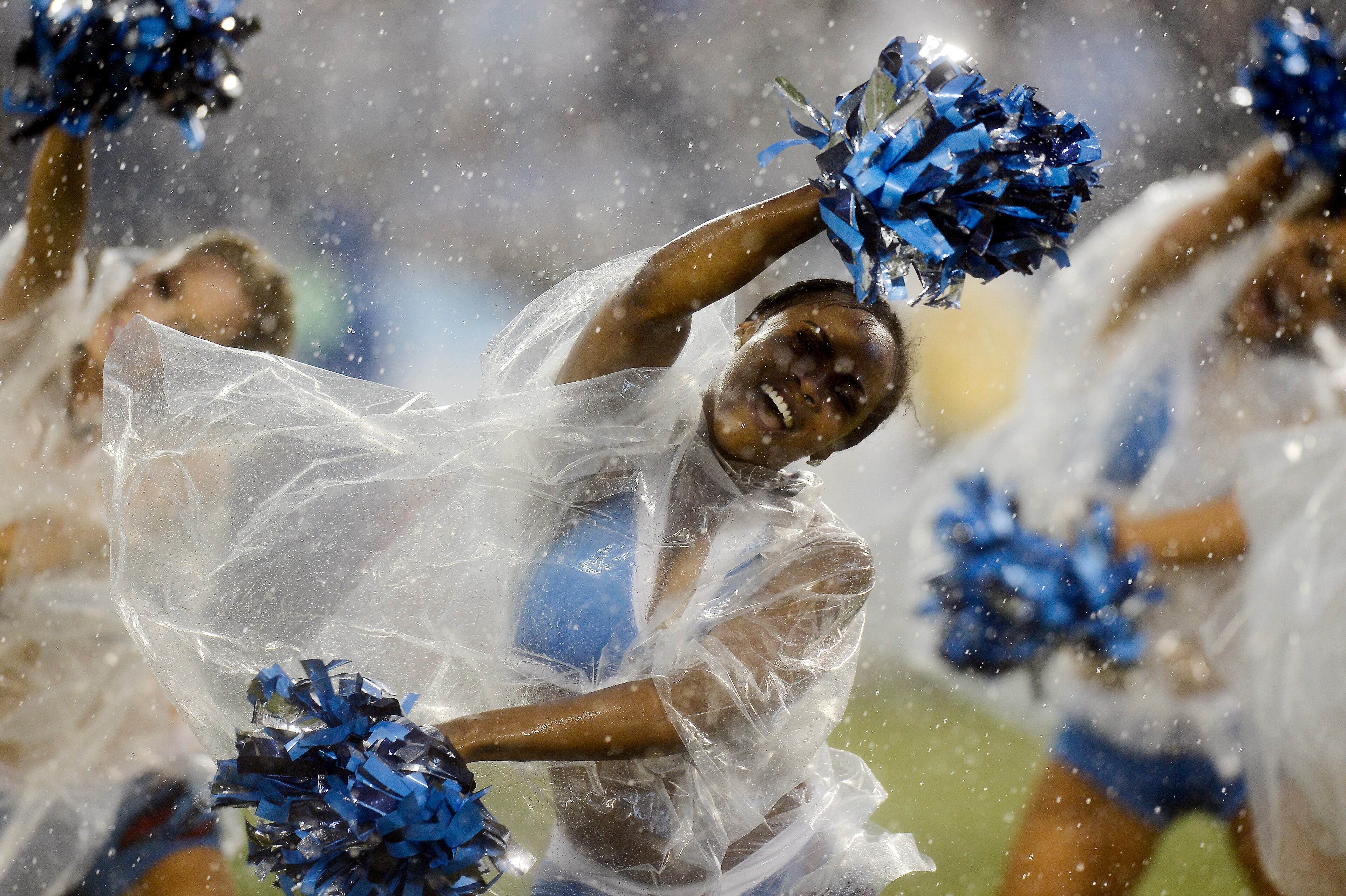 Tennessee Titans cheerleaders perform in the rain during the second quarter of a preseason NFL football game between the Tennessee Titans and the Green Bay Packers Saturday, Aug. 9, 2014, in Nashville, Tenn. (AP Photo/Mark Zaleski)