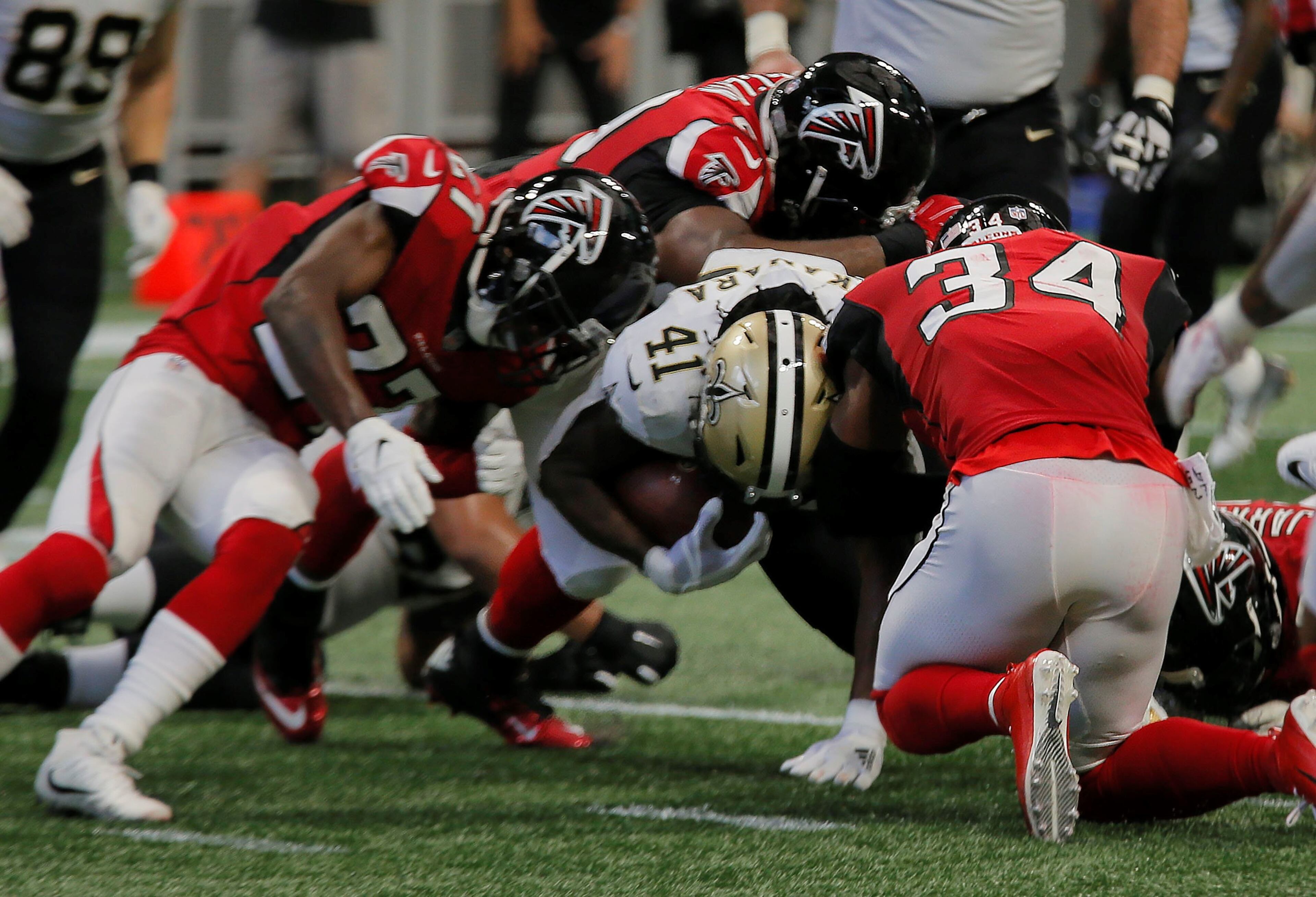 9/23/18 - Atlanta - Falcon defenders stop New Orleans Saints running back Alvin Kamara (41) short of the goal line to force a field goal. The Atlanta Falcons played the New Orleans Saints in an NFL football game Sunday, Sept 23, 2018, at Mercedes-Benz Stadium in Atlanta, GA. BOB ANDRES /BANDRES@AJC.COM
