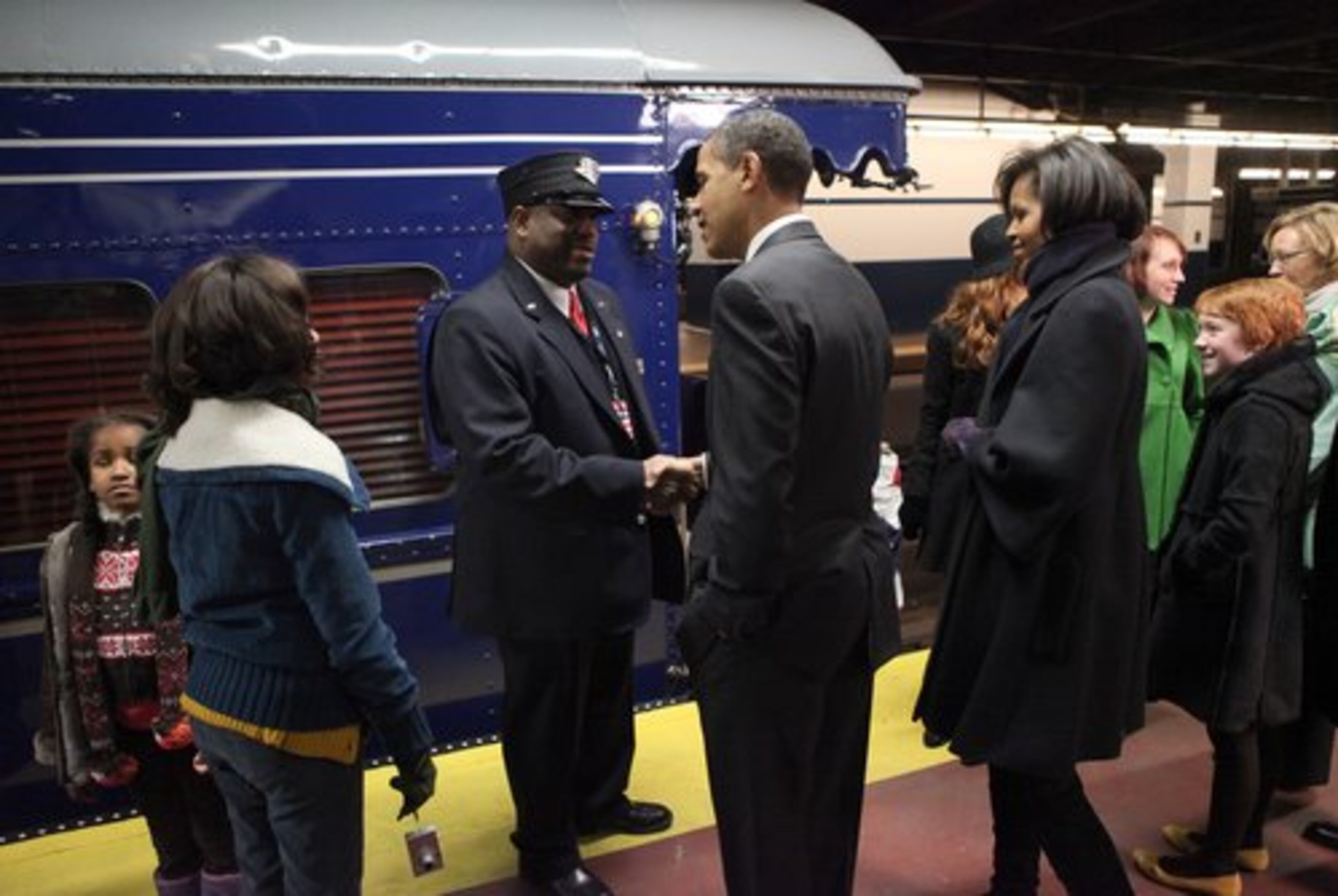 Obama greets Amtrak conductor Noel Powell at Philadelphia's 30th Street Station.