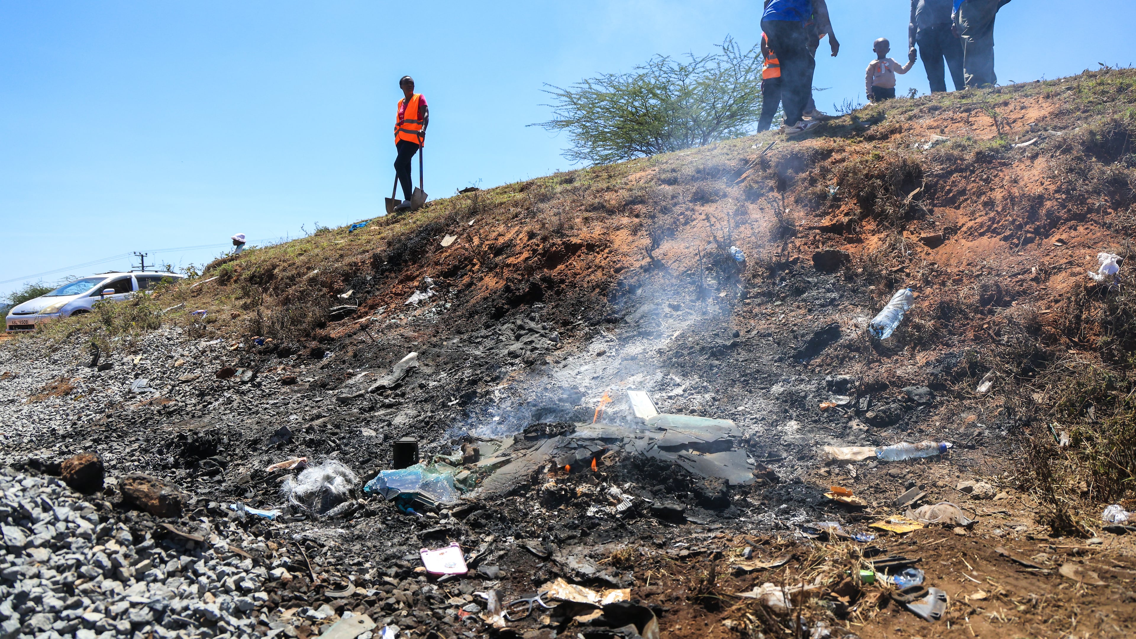 People gather at the scene where a 14-seater mini bus was involved in an accident killing all the passengers, in the Salama area, Makueni County, Eastern Kenya, Saturday, Oct. 3, 2026. (AP Photo/Andrew Kasuku)