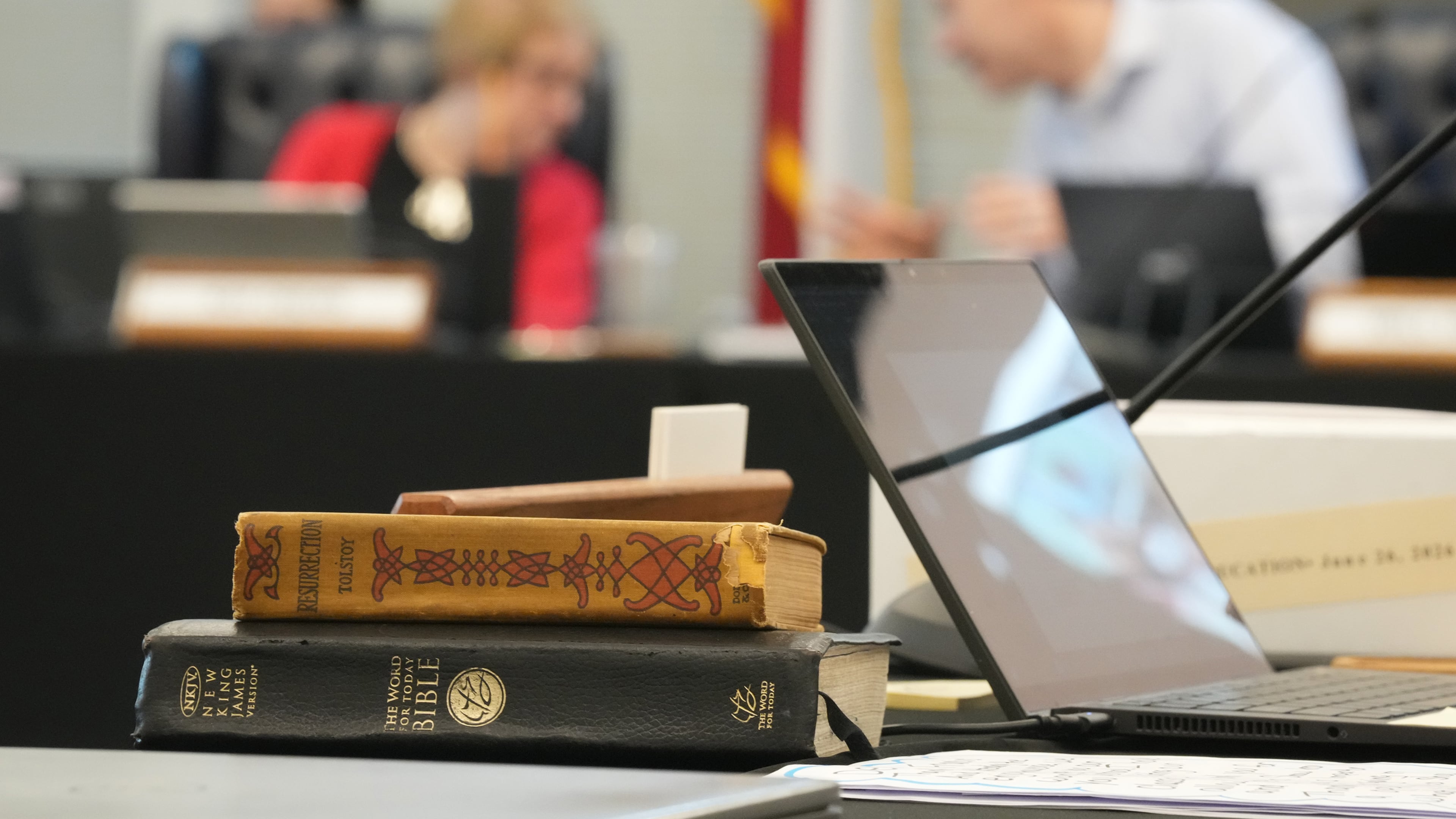A Bible and Resurrection by Leo Tolstoy sit on the desk of State Board of Education member LJ Francis during a meeting on proposed social studies standards at the Barbara Jordan Building in Austin on Monday, June 22, 2026. (Jay Janner/Austin American-Statesman via AP)