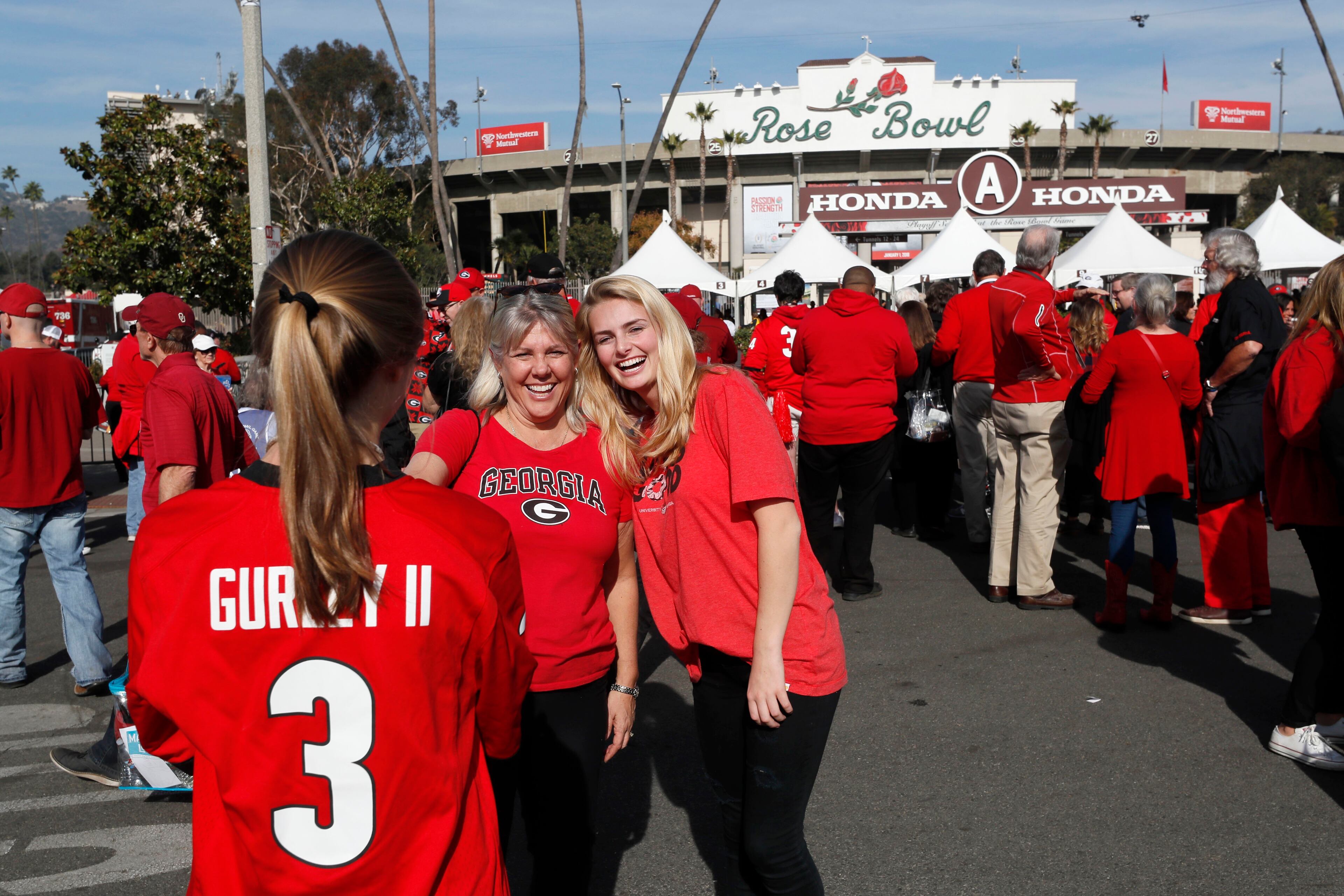 1/1/18 - Pasadena - Amy and Lucy Heneghan, have their photo taken by Lily Holmes, all from Atlanta, as they wait for the team to arrive at the College Football Playoff Semifinal at the Rose Bowl Game on Monday, January 1, 2018, in Pasadena. BOB ANDRES /BANDRES@AJC.COM