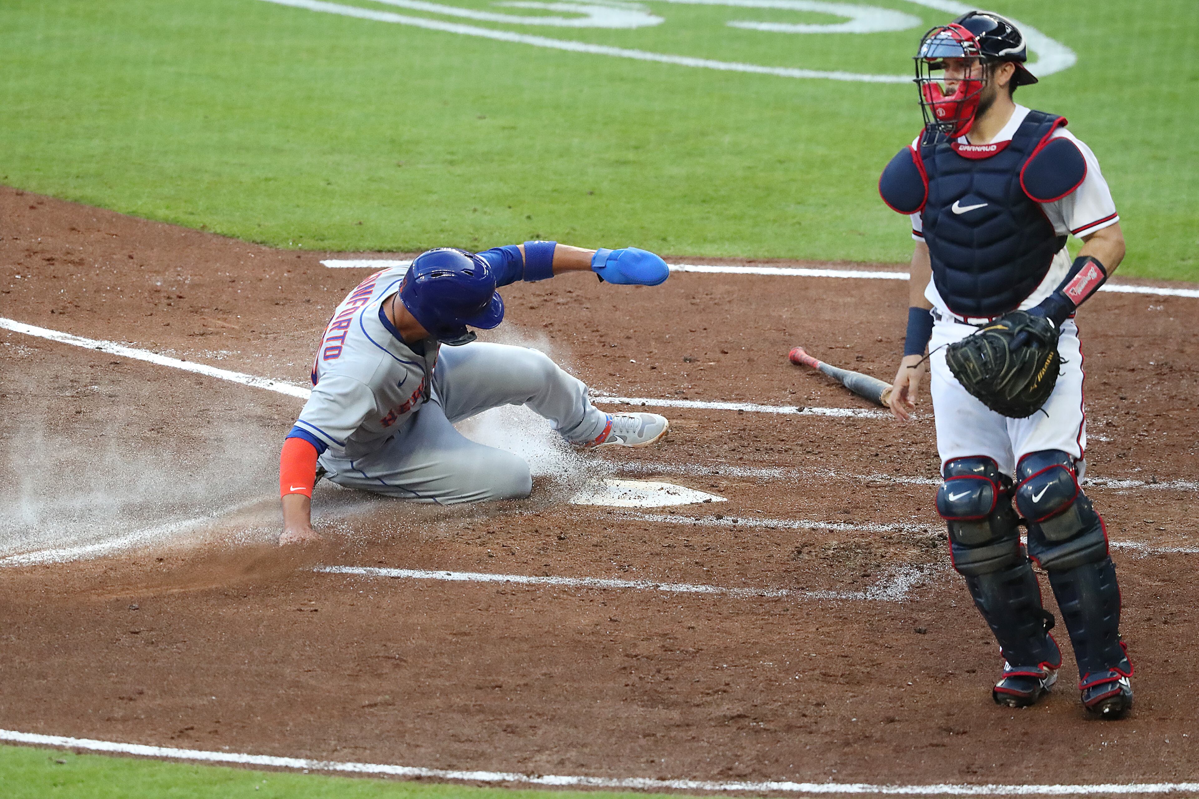 New York Mets Michael Conforto scores past Atlanta Braves catcher Travis D’Arnaud on a 2 RBI single by Robinson Cano’ to take a 3-0 lead over the Atlanta Braves during the third inning in a MLB baseball game on Monday, August 3, 2020 in Atlanta. Curtis Compton ccompton@ajc.com