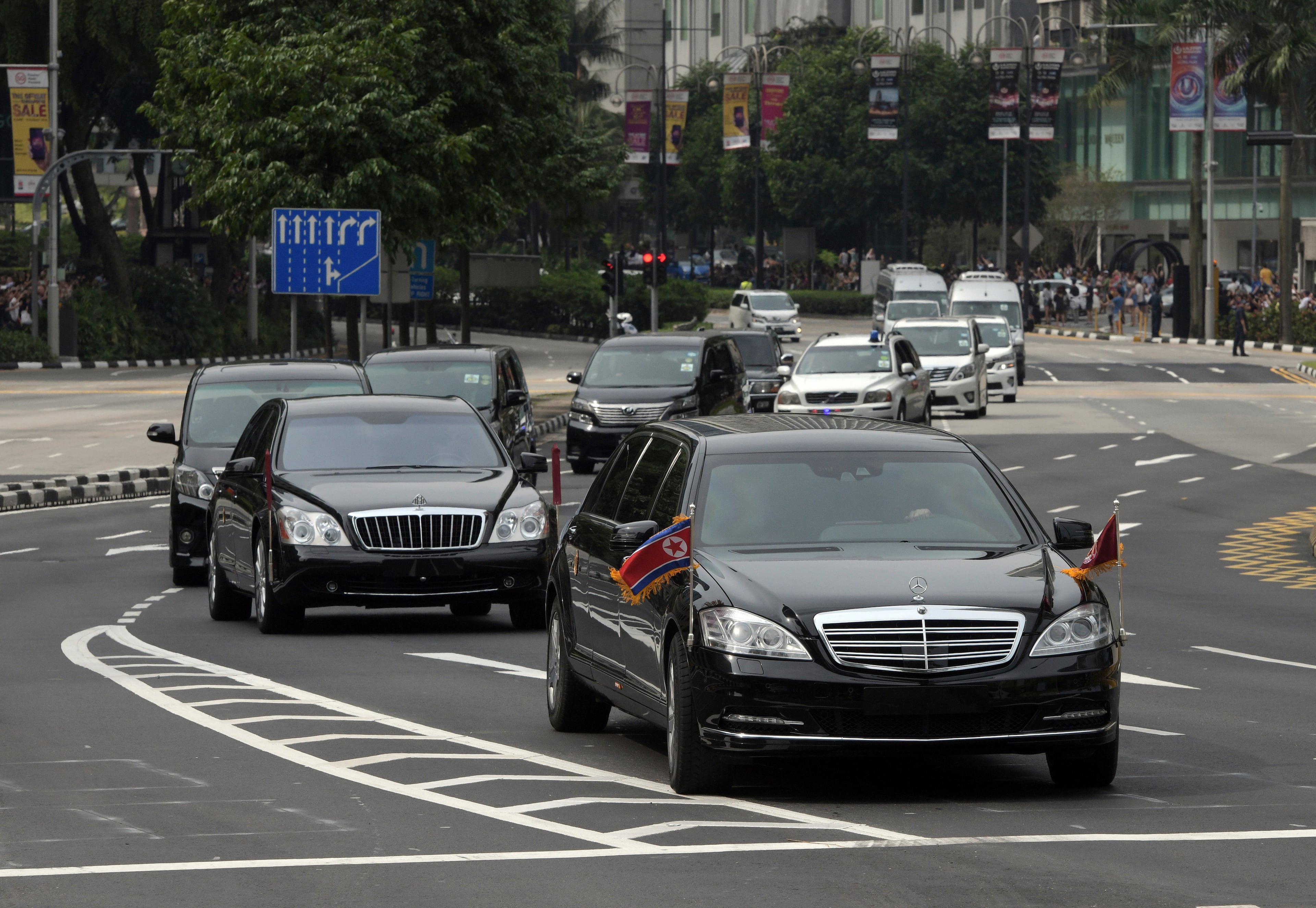 The North Korean motorcade, believed to be carrying North Korean leader Kim Jong Un, travels along Singapore's Orchard Road, Sunday, June 10, 2018, ahead of the summit with U.S. leader Donald Trump. (AP Photo/Joseph Nair)