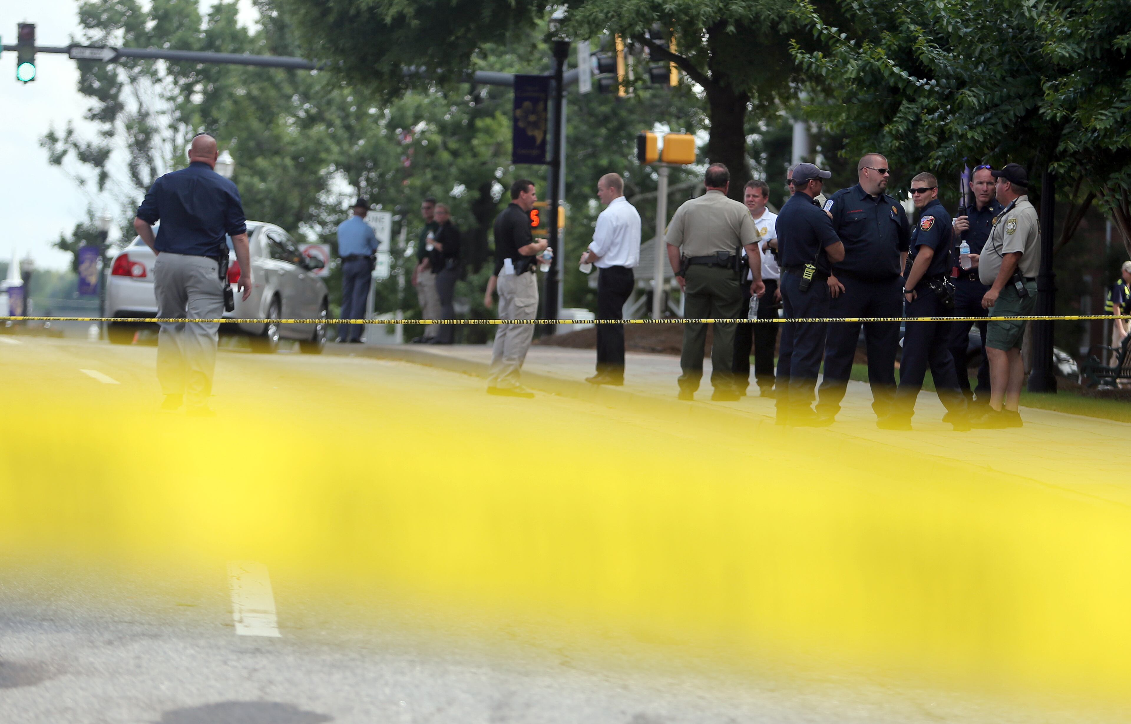 First responders wait near the Forsyth County Courthouse in Cumming on Friday afternoon June 6, 2014 following a morning shoot out that left one deputy injured and the perpetrator dead.